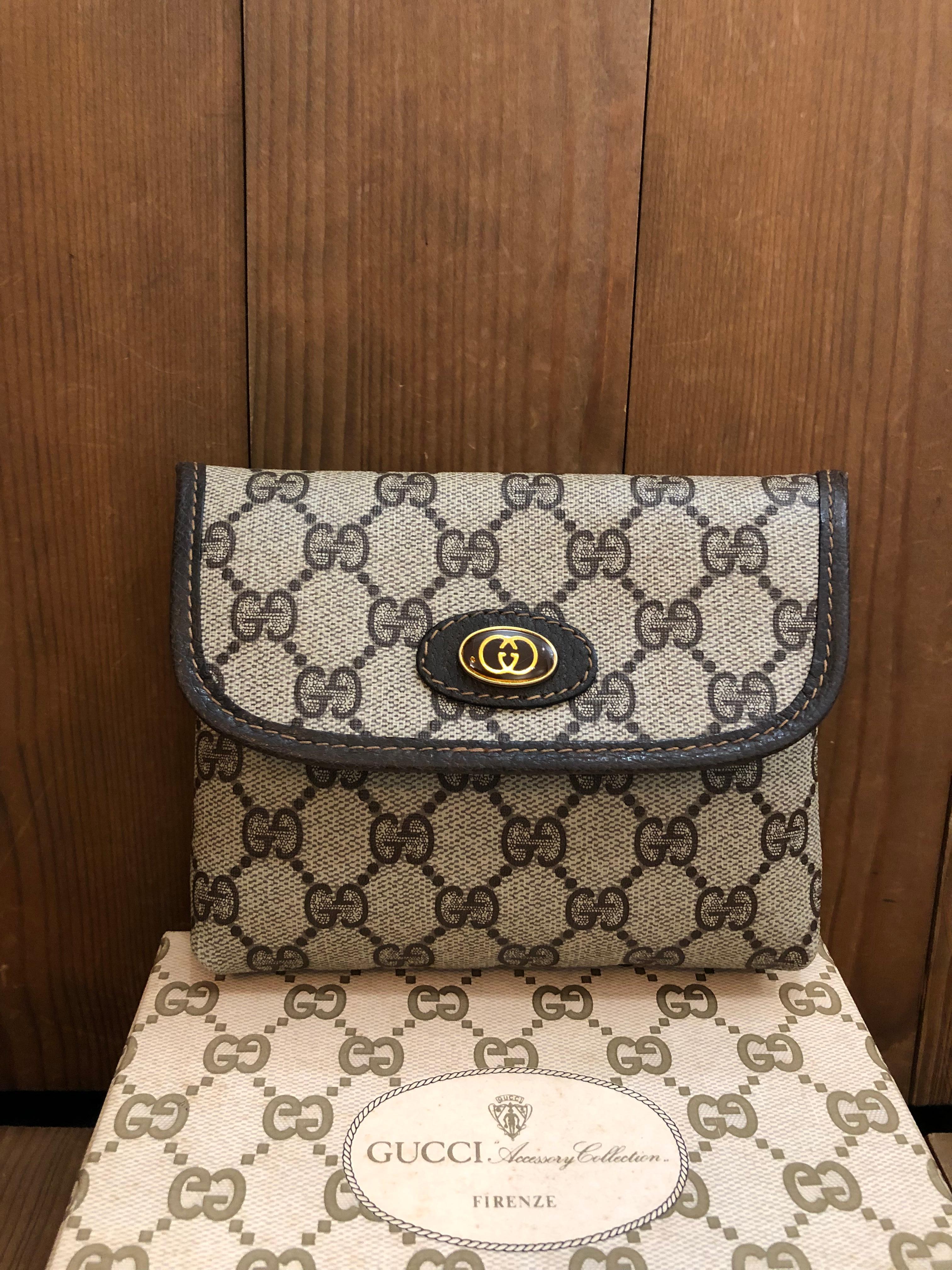 This vintage GUCCI pouch bag is crafted of GG monogram canvas in brown trimmed with brown leather. Front snap closure open to a laminated monogram interior. Made in Italy. Measures 5.75 x 5 x 1.5 inches. Comes with box.

Condition - Excellent