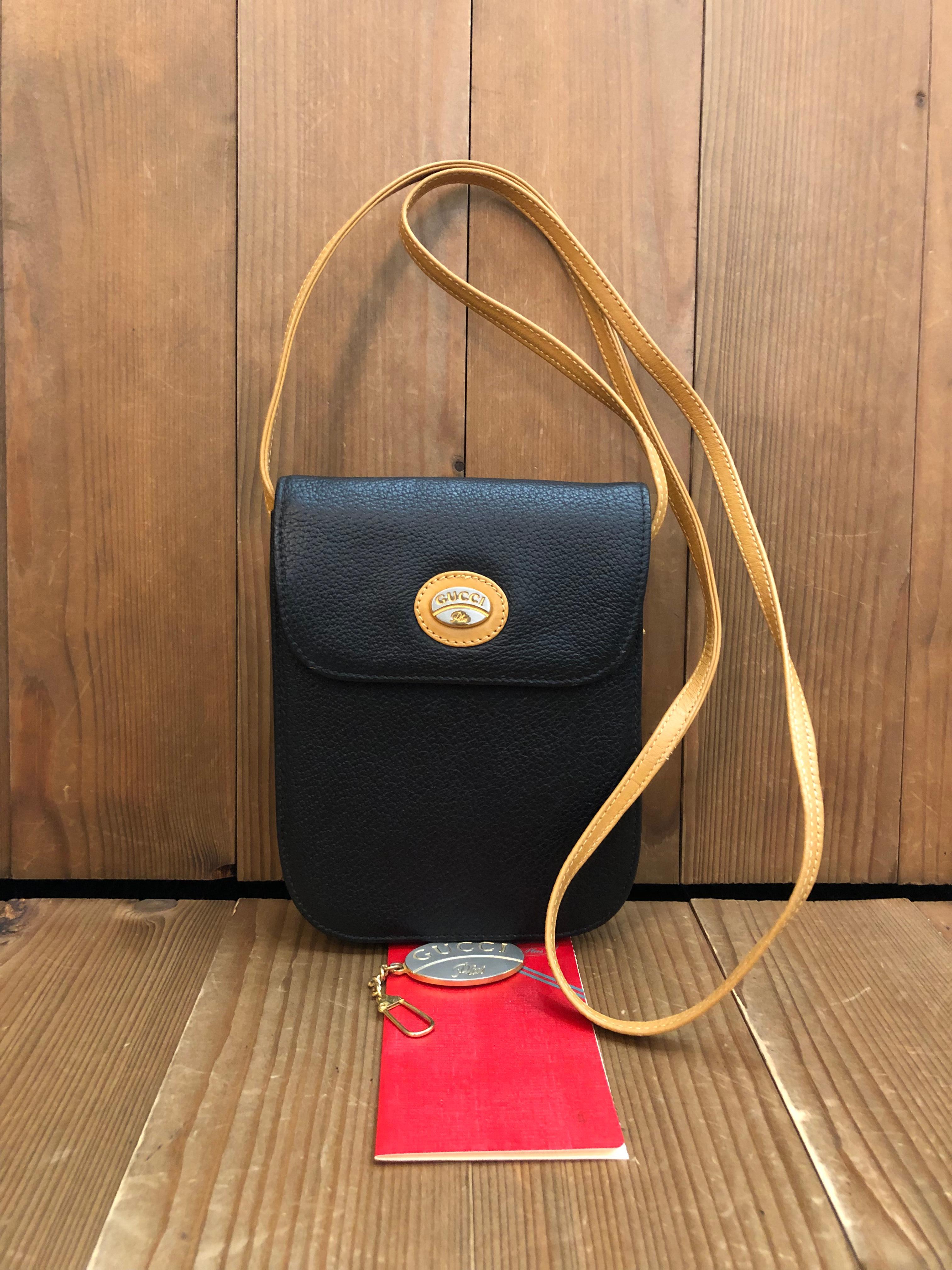 This vinatge GUCCI Plus mini crossbody bag is crafted of calfskin leather in black and beige. Front flap magnetic snap closure opens to a beige velvet interior featuring a patch pocket. It is the perfect cell phone pouch. Measures approximately 5 x