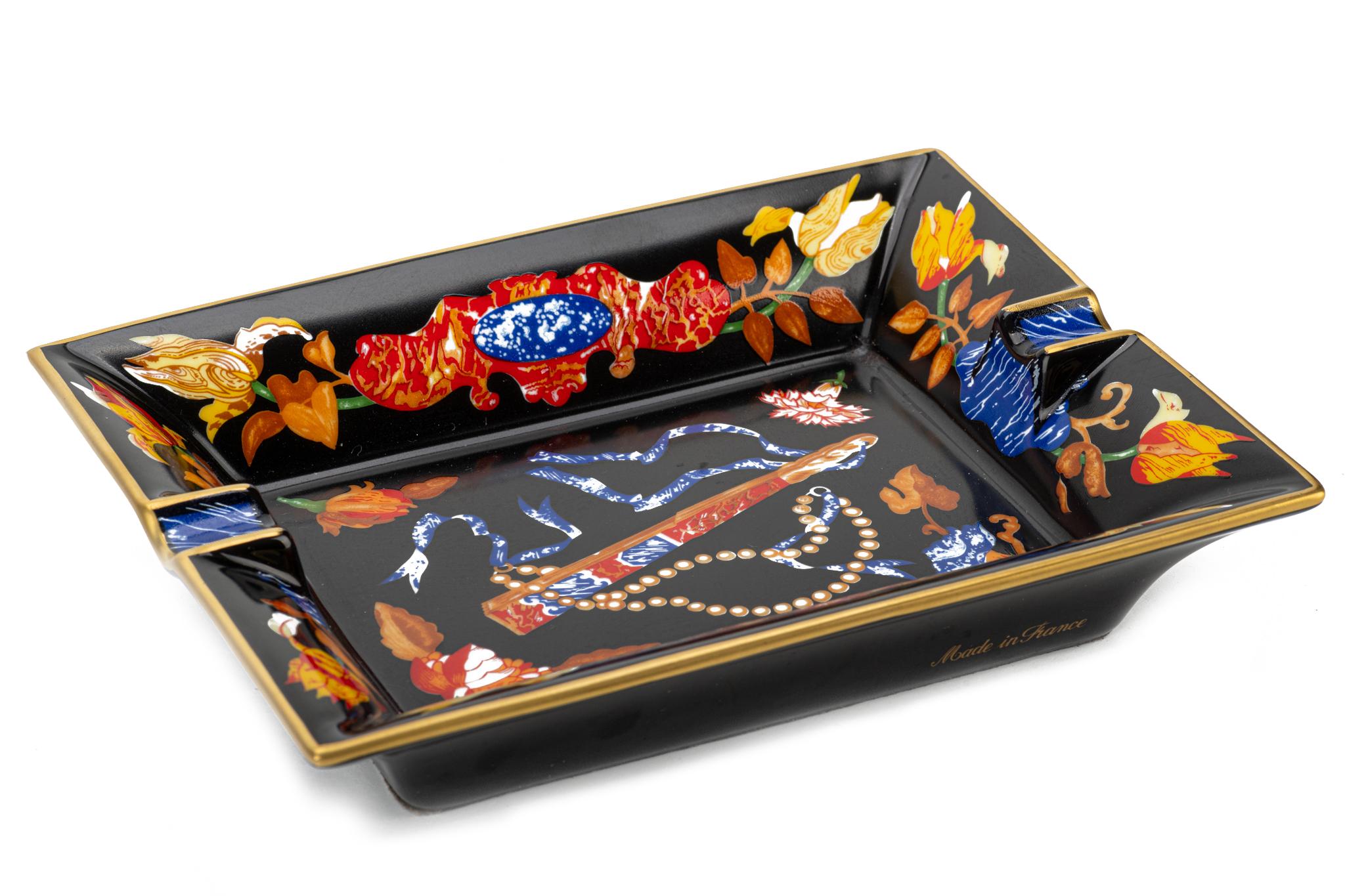 Hermes rare and collectible black porcelain ashtray with black suede bottom, Fan and flowers design. Mint condition. 
