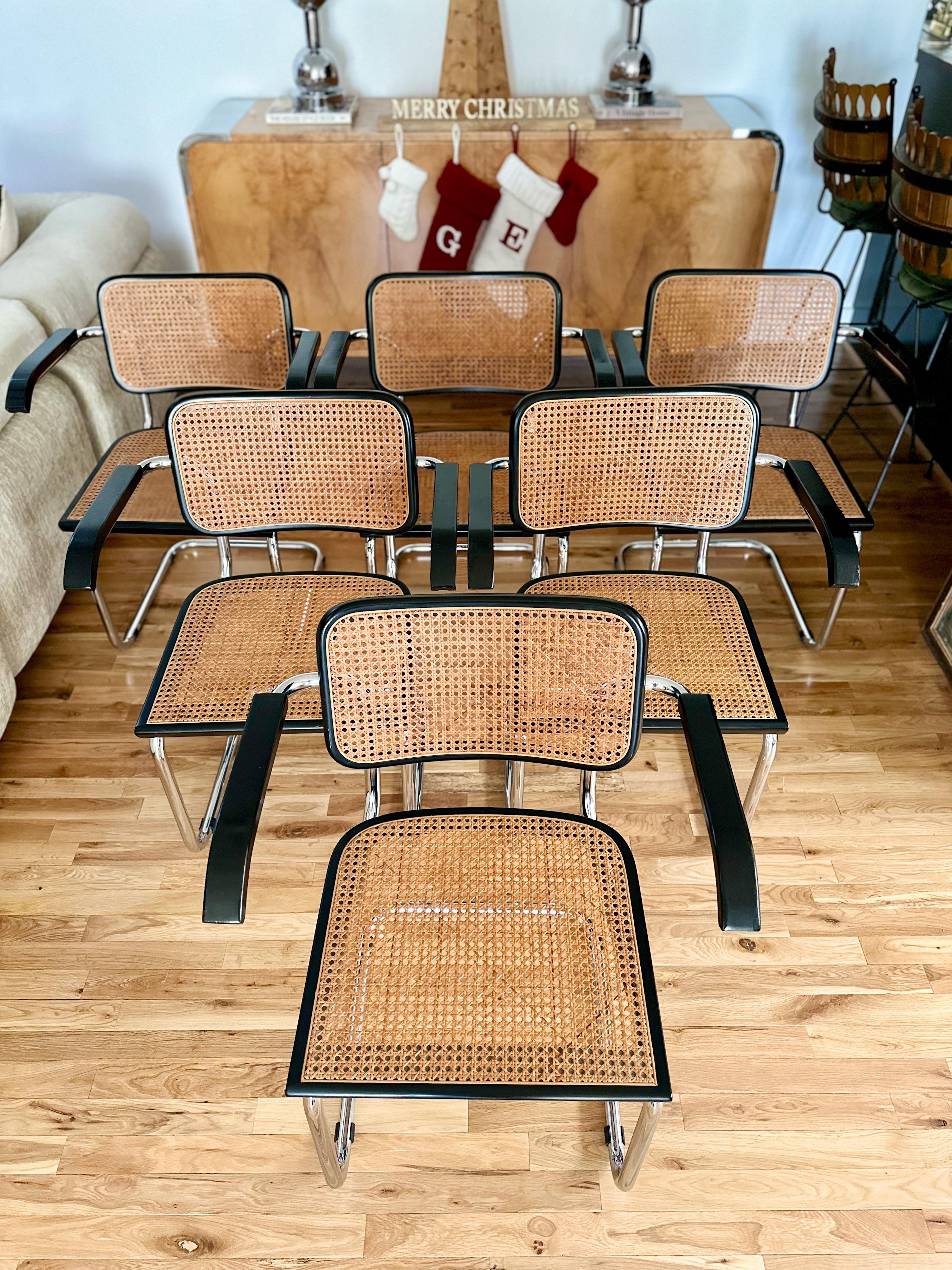 Iconic set of six vintage Italian Cesca armchairs attributed to Marcel Breuer. Designed in 1928 and still made to this day, Cesca chairs epitomize Bauhaus design and vintage sets are coveted and collectible. The black finish and armed configuration
