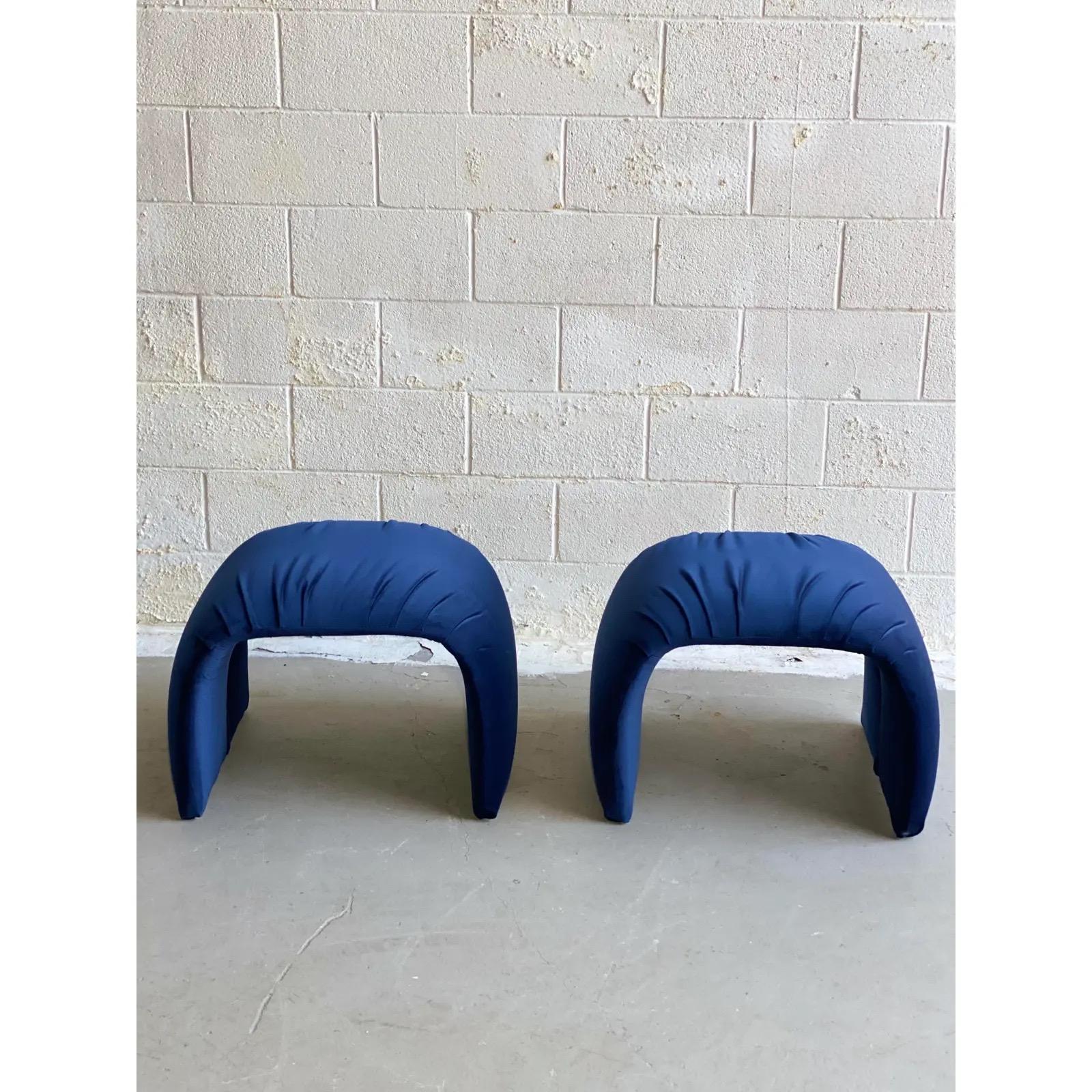 We are very pleased to offer a chic, vintage pair of ottomans, circa the 1980s. Layer a space or add extra seating with these eye-catching ottomans wrapped in a new rich, velvet blue fabric. In excellent condition and ready to be used for years to