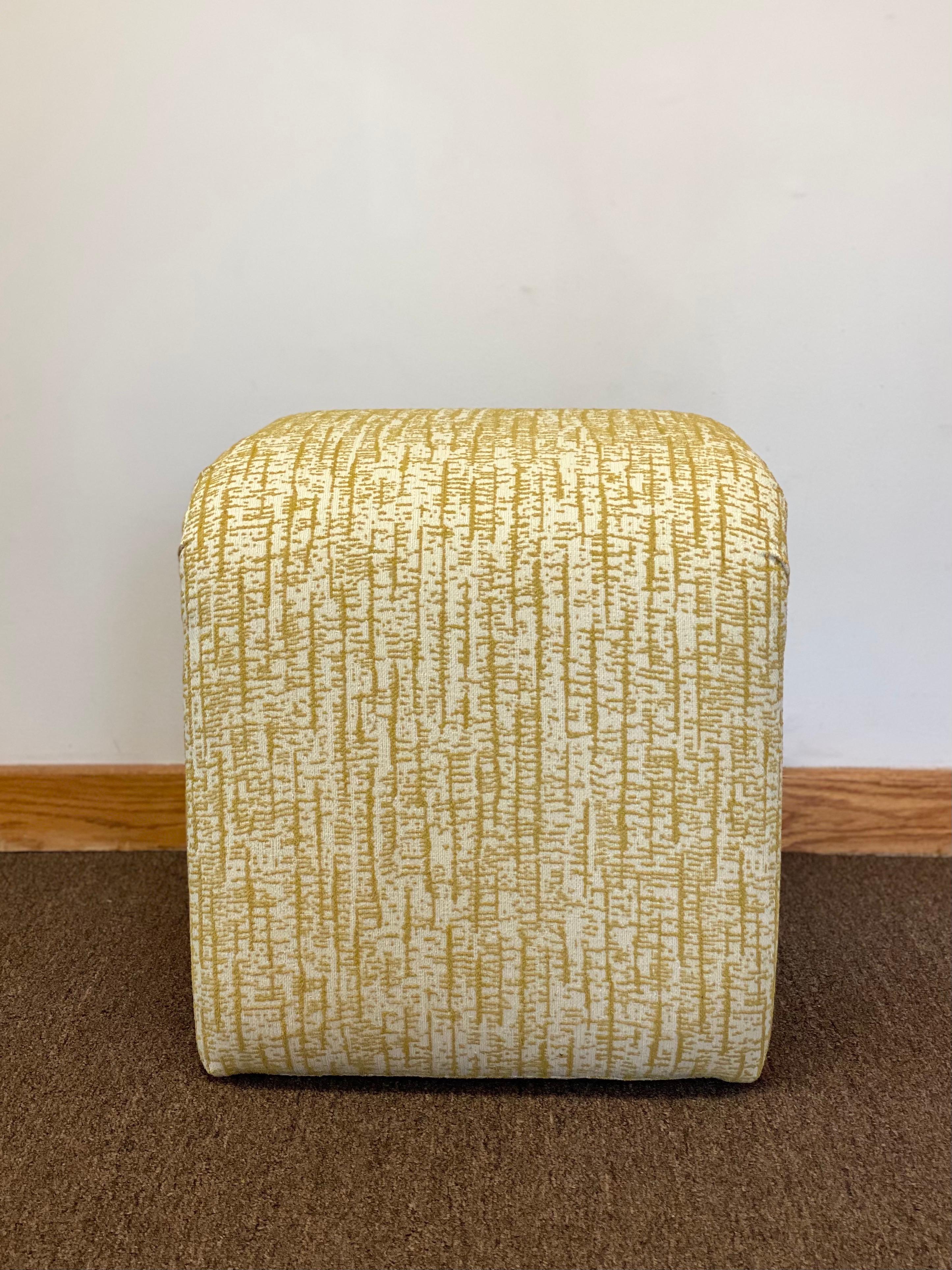We are very pleased to offer a fabulous, Mid-Century Modern, upholstered bench in the manner of Karl Springer. This piece is structurally sound and has been reupholstered in a new yellow mustard and white modern fabric. In excellent condition,