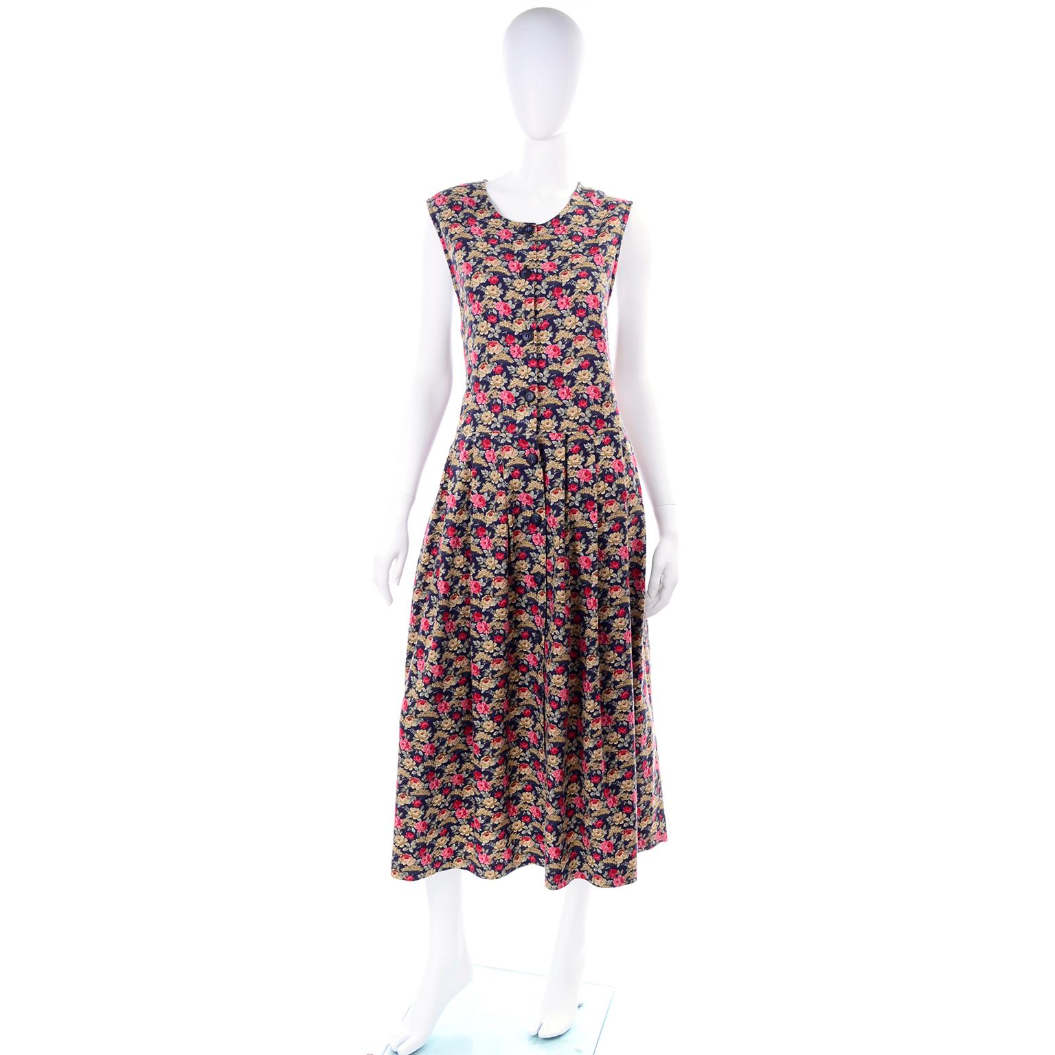 This is a pretty vintage Laura Ashley dark blue cotton dress with pink, red and mustard yellow flowers with green gray leaves.  We acquired this from an estate we handled of incredible designer clothing. The woman had only the finest pieces in her