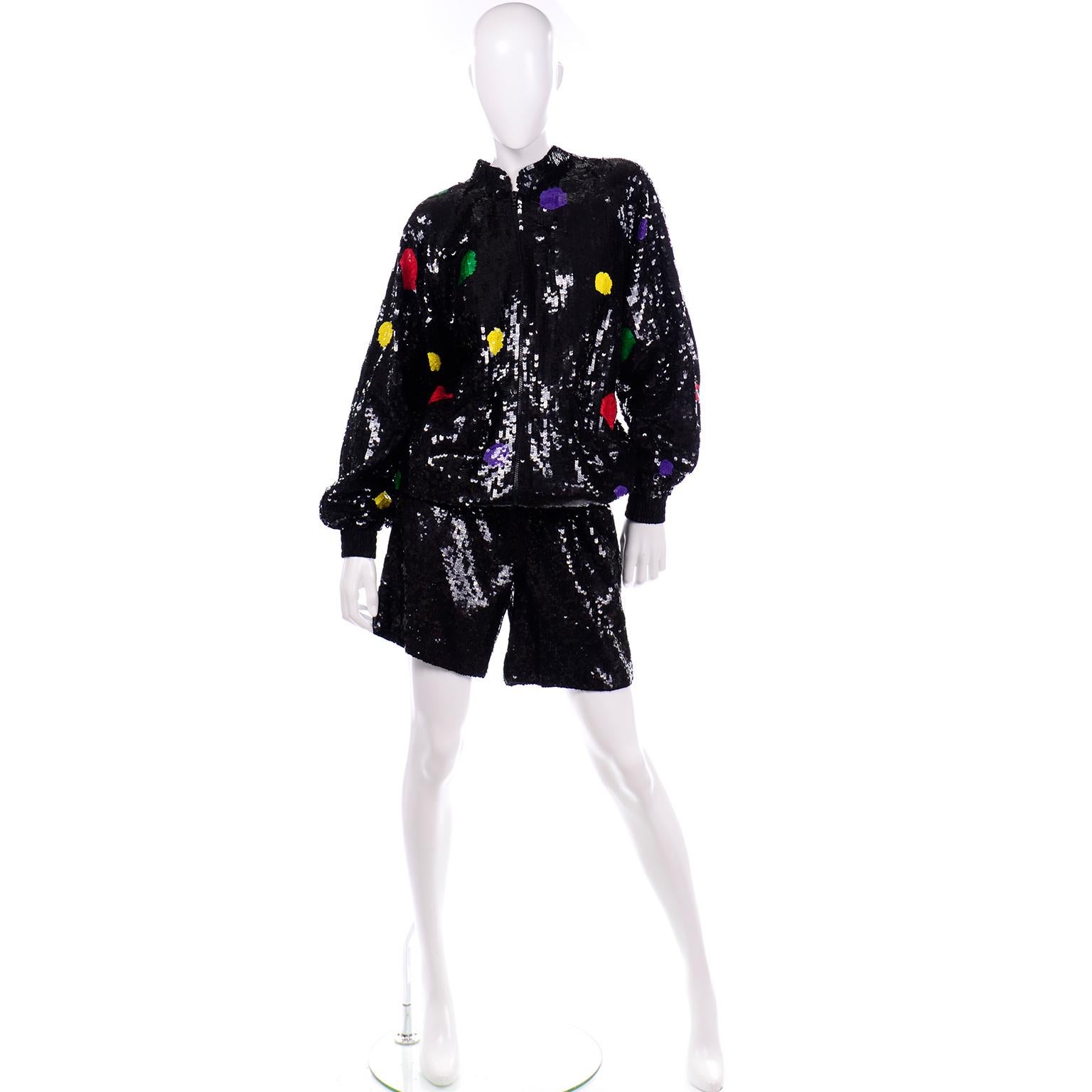 This is a show stopping vintage 1980's Lillie Rubin short set that includes a pair of elastic waist shorts and a sweatshirt style zip front jacket. The base color of both pieces is black and the jacket has sequin polka dots in bold shades of 