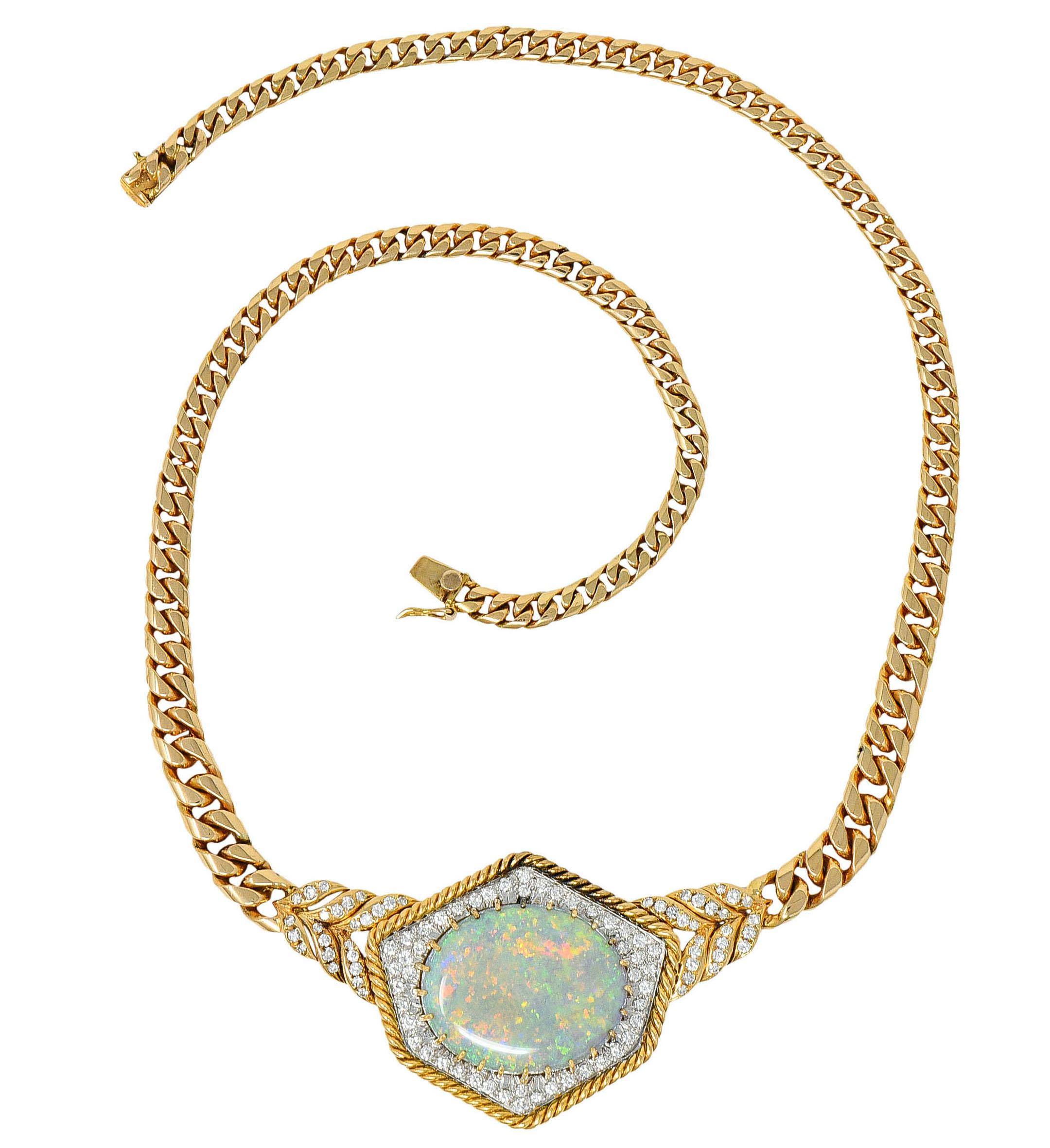 Statement necklace is designed with a polished gold cuban chain and centers a hexagonal twisted rope station

Featuring a claw set opal cabochon measuring approximately 25.3 x 20.5 mm; with strong spectral play-of-color

Surrounded by round