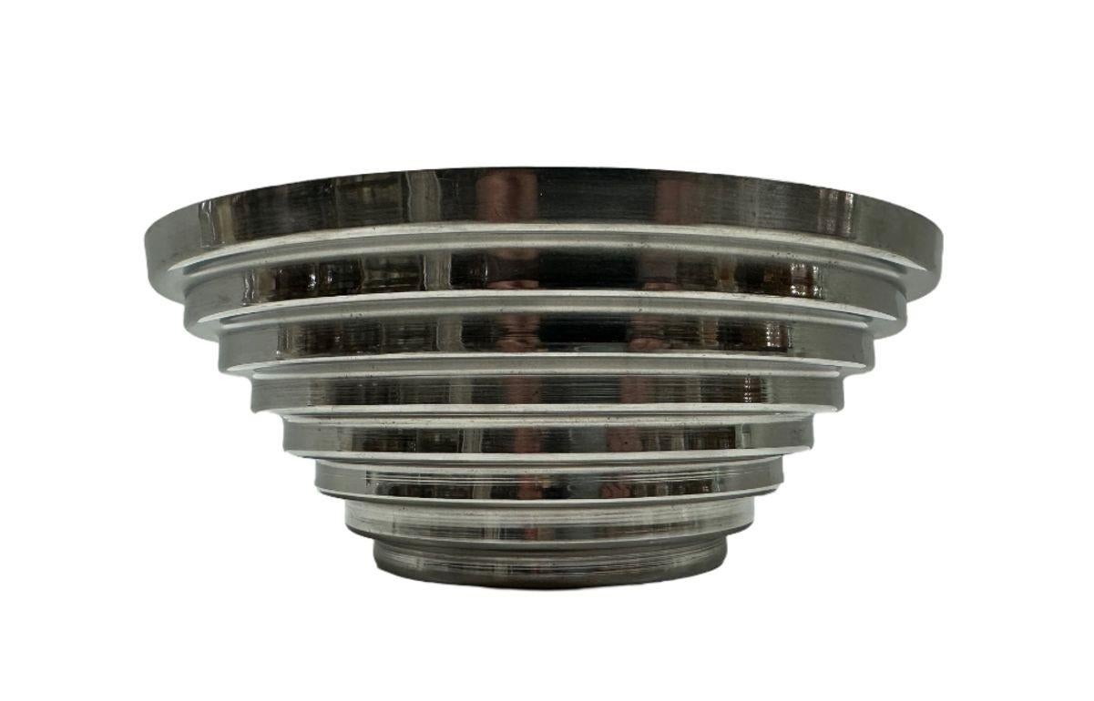 Unique stainless steel serving bowl that will look great with your mid-century modern dinnerware or in your 1980s-style kitchen.

10 inches in diameter
4 inches in height