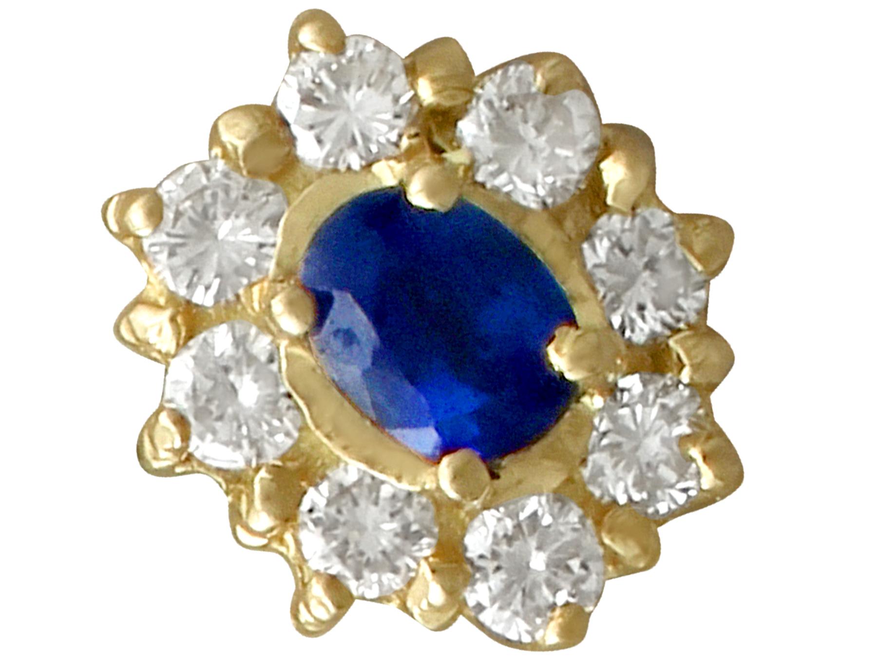 An impressive pair of vintage 0.40 carat blue sapphire and 0.32 carat diamond, 18k yellow gold cluster earrings; part of our diverse gemstone jewelry collections.

These fine and impressive sapphire and diamond cluster earrings have been crafted in
