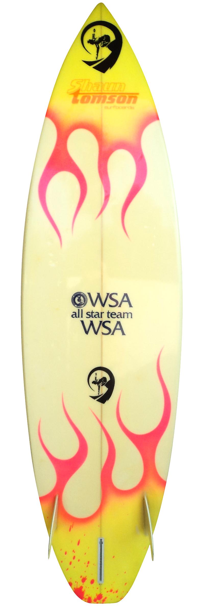 Mid 1980s Shaun Tomson WSA All Star Team 2+1 surfboard shaped by Don Kadowaki. Features an airbrushed flame design with Batman theme traction pad. WSA All Star Team surfboard bag included in the sale. A fantastic example of a 1980s vintage team