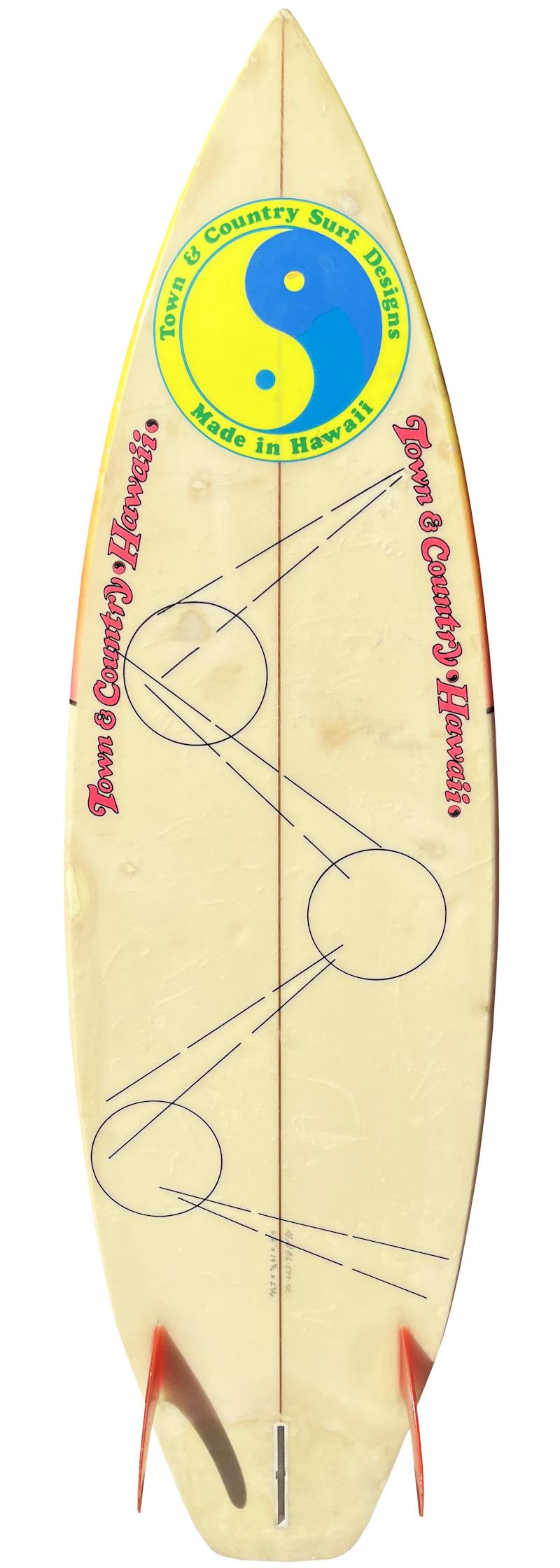 1986 Town and Country surfboard made by Greg Griffin. Features an original airbrush design indicative of the 80s and 2+1 fin setup. This board has airbrush artwork nearly identical to that of a personal surfboard belonging to New Zealand born actor