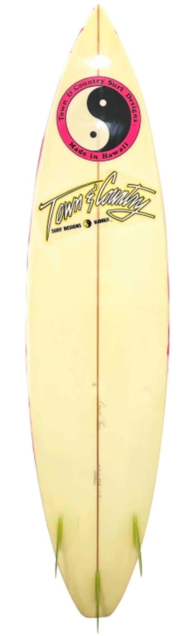 1989 Town & Country surfboard shaped by Dennis Pang. Features an uncommon hand-brushed paint design with translucent yellow glassed on thruster (tri-fin) setup. This is an extremely rare find due to the near mint original condition the board remains
