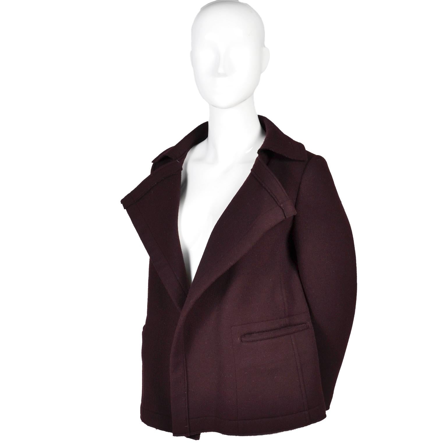 This is a great Yohji Yamamoto deep plum purple wool blend vintage jacket. This is an open front blazer with no buttons or fasteners. There are two pockets at the waist and raw hems. This great piece was made in Japan in the early 1990's and fits a