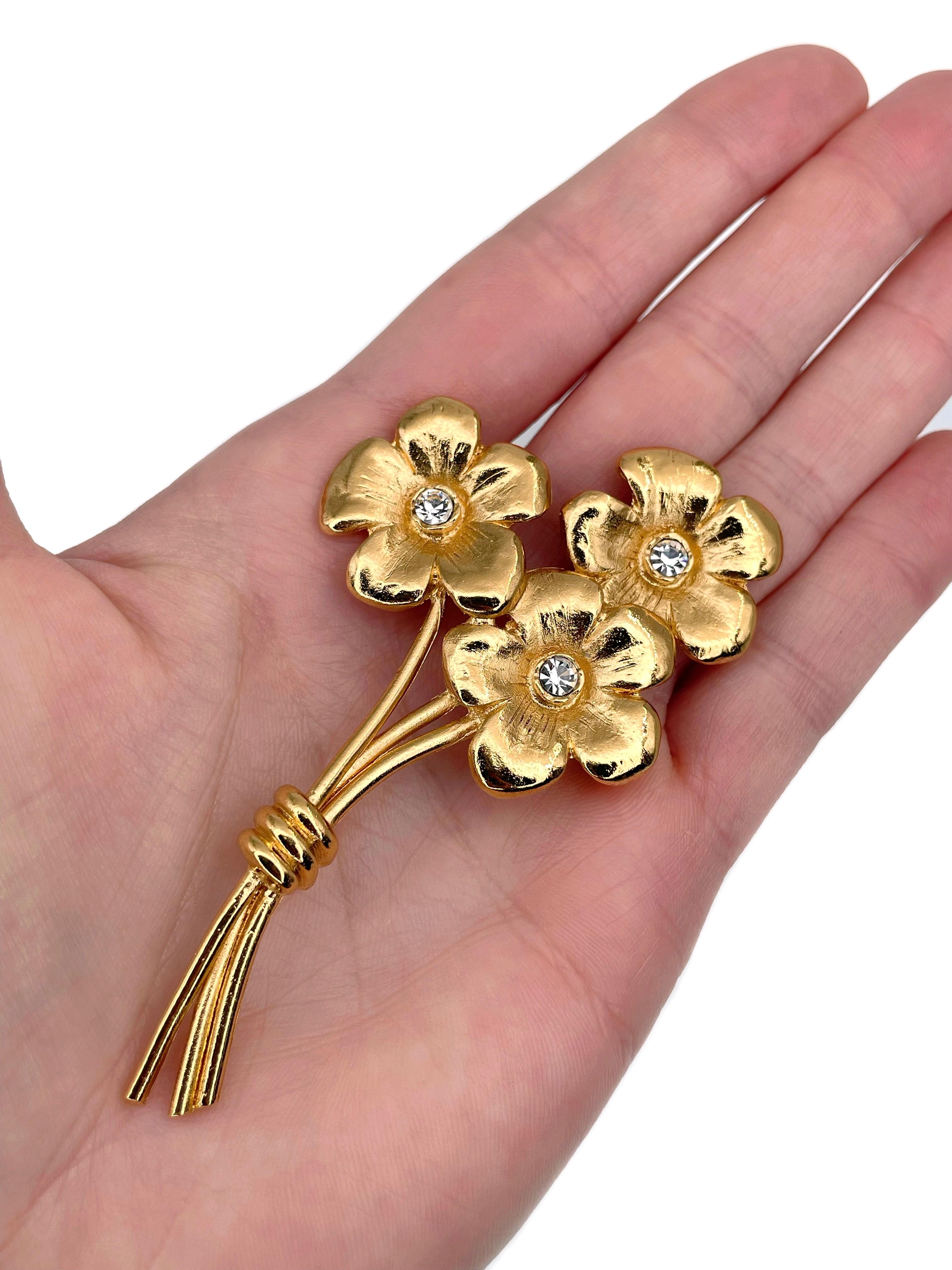This is a gold tone flower bouquet pin brooch designed by YSL in 1980’s. 

The piece is gold plated. It features clear rhinestones. 

Signed: “YSL. Made in France” (shown in photos).

Size: 8x4.7cm

IMPORTANT: As a buyer, you are fully responsible