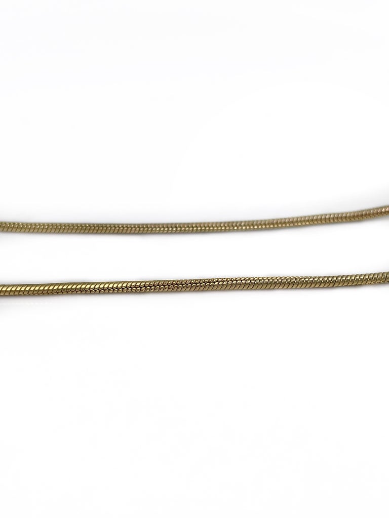 CASSANDRE snake brooch in metal, Saint Laurent