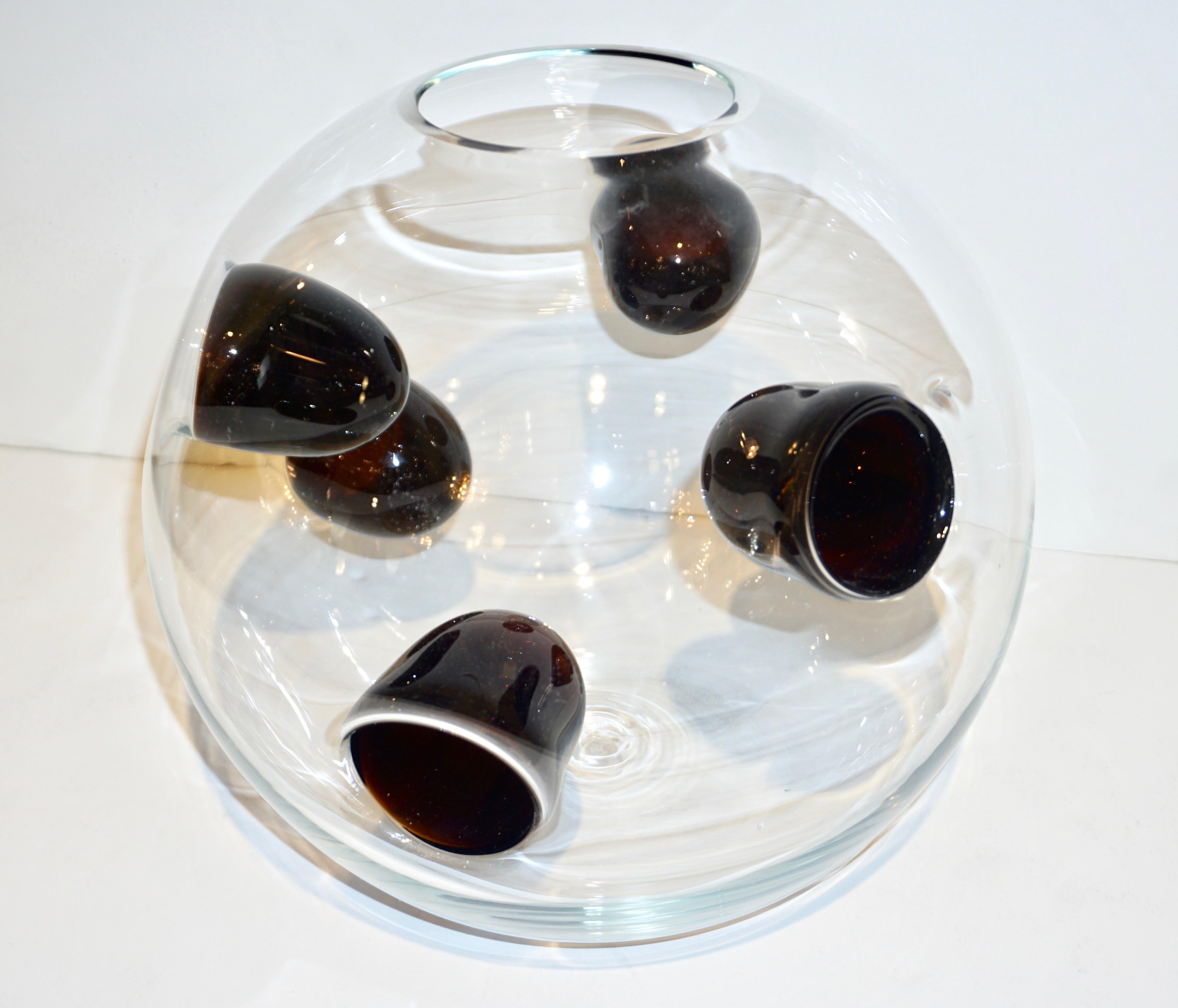 A unique blown deconstructed creation by Vistosi in Memphis Group style worked with an unusual and rare technique, the decor in the crystal clear Murano glass organic body consists of blown asymmetrical sunken bubbles in a brown red plum color, a