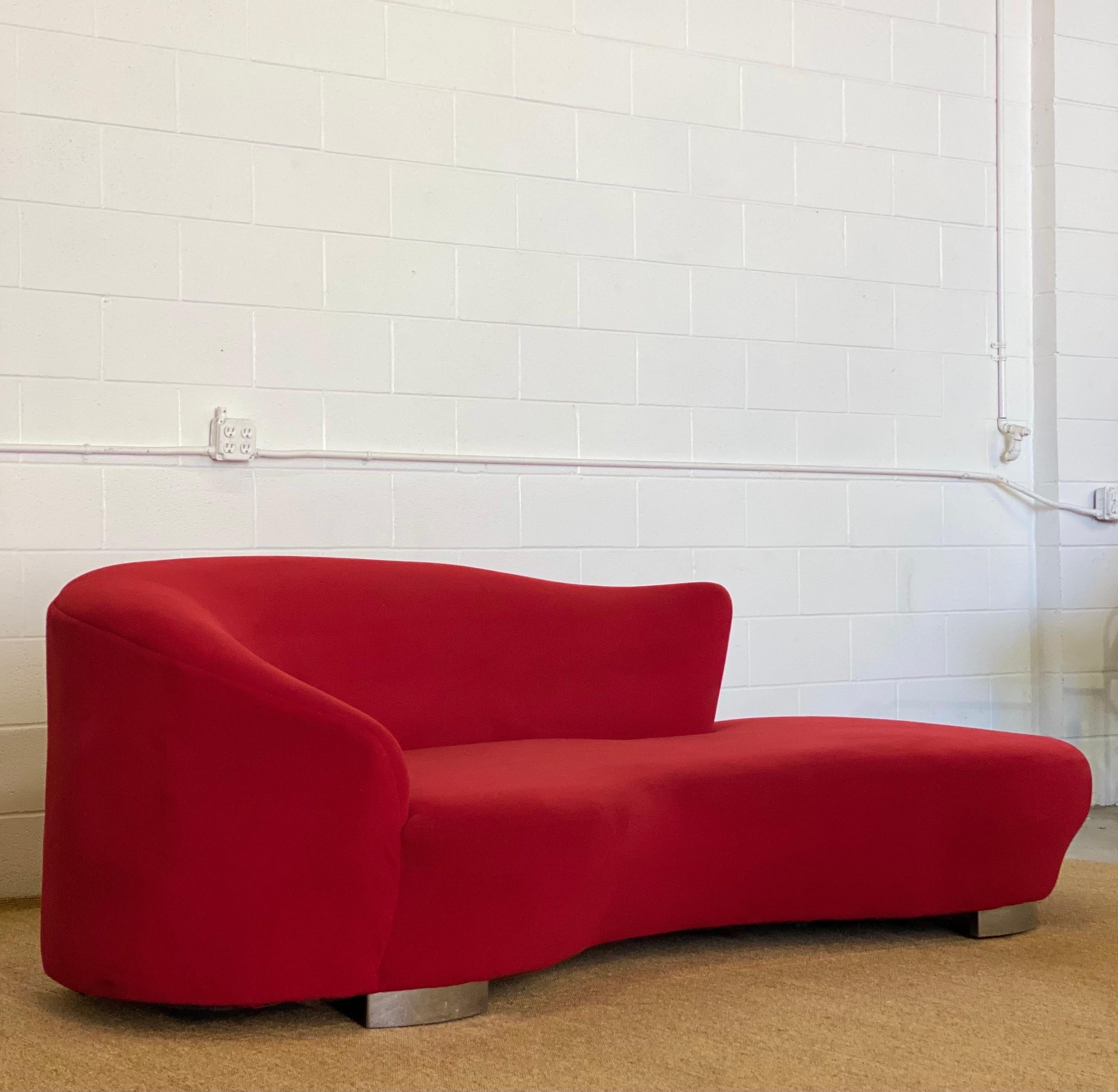 We are very pleased to offer a stunning cloud sofa, circa the 1980s. This biomorphic sofa sits on four chrome legs and features a red microsuede fabric. This piece is structurally sound, but fabric shows some blemishes and stains; thus, reupholstery
