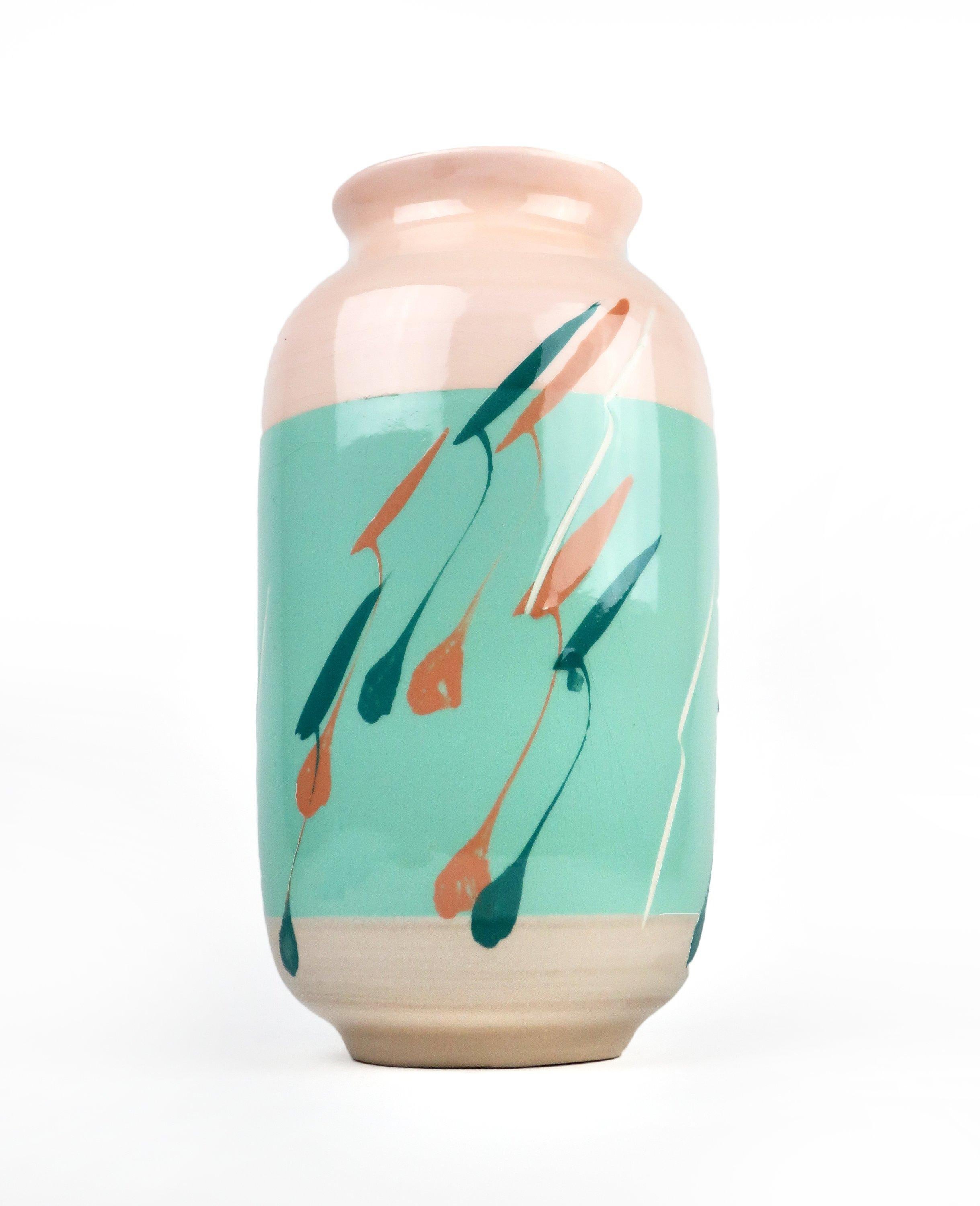 Beautifully hand painted vase in coral and turquoise, with white, green and tan decoration. Sticker on base reads “An Original Design by Vohann of Calif, Inc.”

Excellent vintage condition with light shelf wear.

Measures: 6