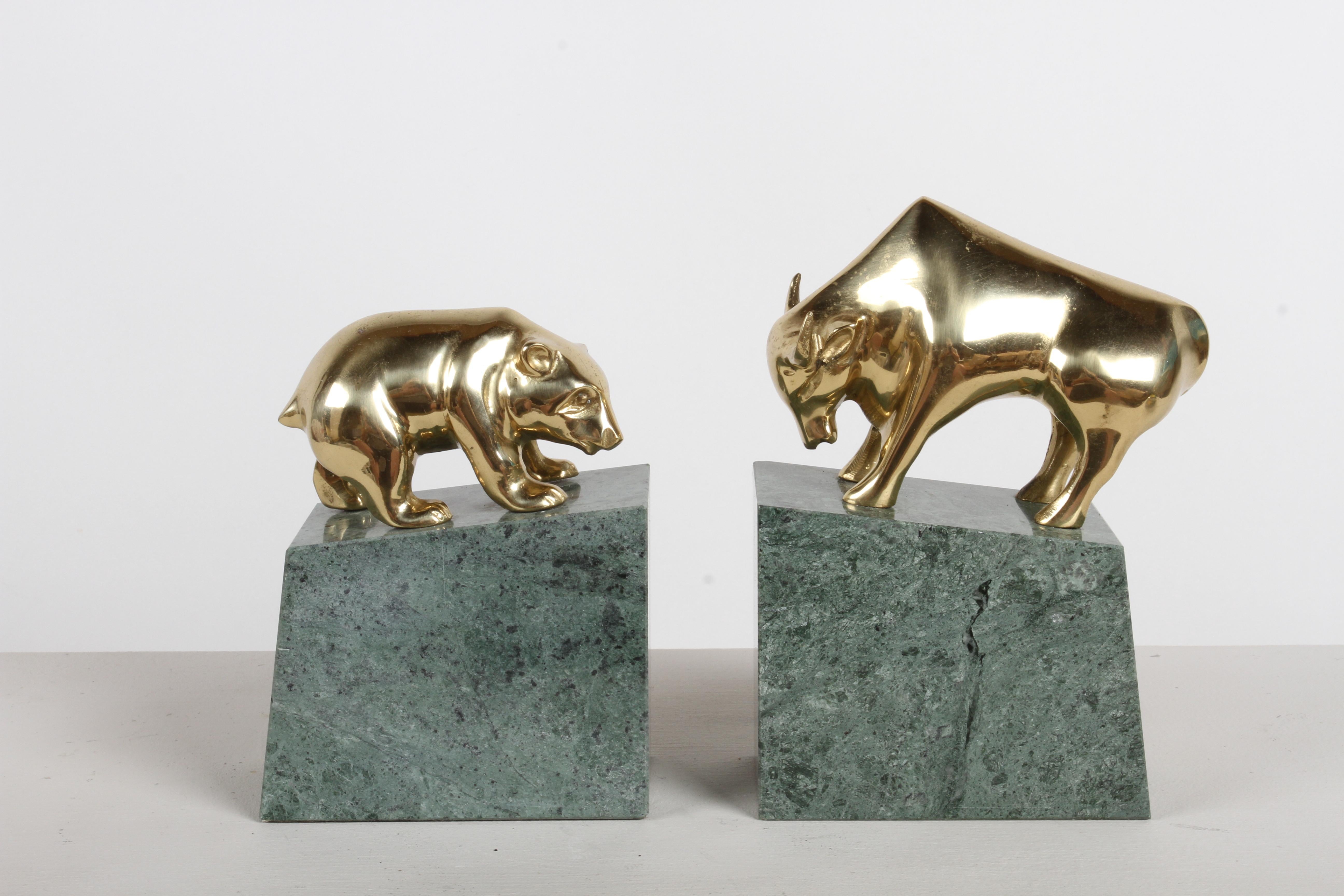 1980s Wall Street Bear & Bull stock market bookends . Each having a cast brass design on top of a solid block of angled green marble base.  Perfect gift for that Wall Street broker, advisor or trader. 

Bull 7.75