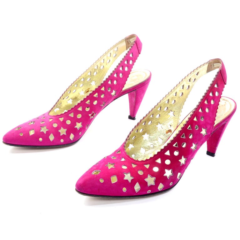 These are really fun vintage Walter Steiger slingback heels in a magenta pink suede The shoes have a cutout upper opening and punched out triangle, circle, diamond and star shapes! Size 7AA and Made in Italy. 
HEEL: 3