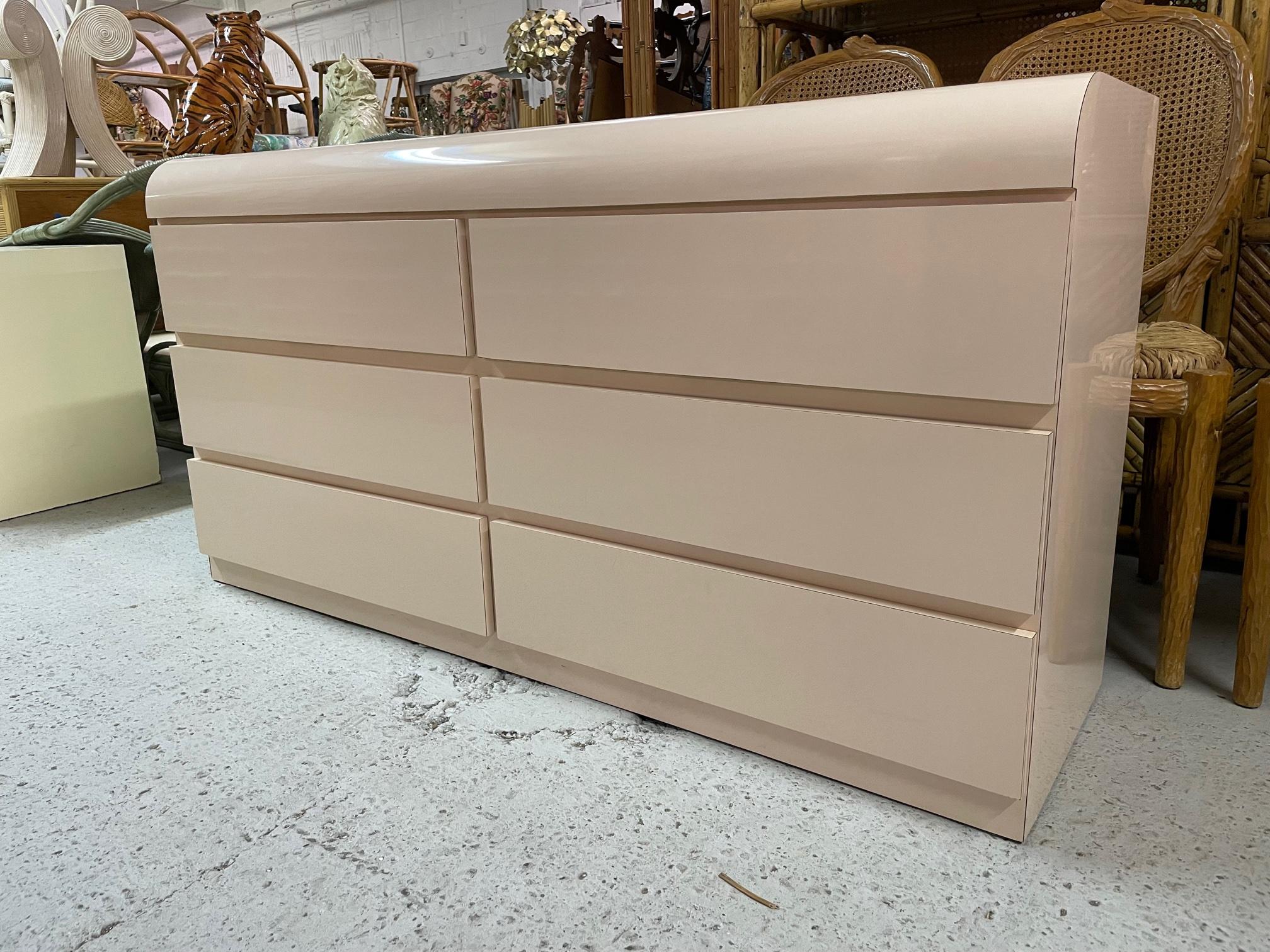 80s double dresser features smooth waterfall front and a solid plinth style base. Styling reminiscent of Karl Springer. Very good condition with only very minor imperfections and drawers operate like new.
Shipping to most of the continental US is