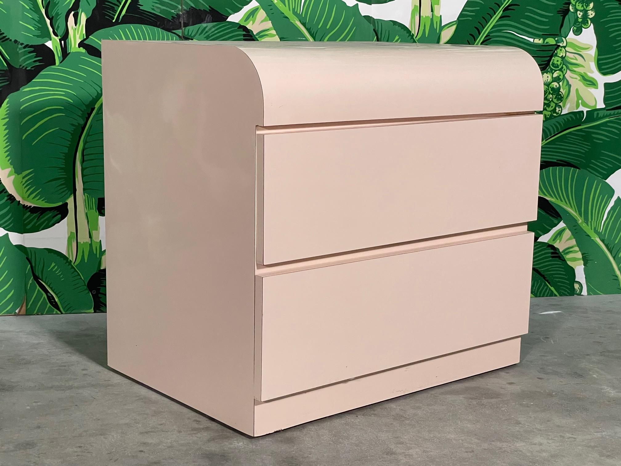 80s era nightstand features smooth waterfall front and a solid plinth style base. Styling reminiscent of Karl Springer. Good condition with minor imperfections and drawers operate like new. See photos for condition details. 

