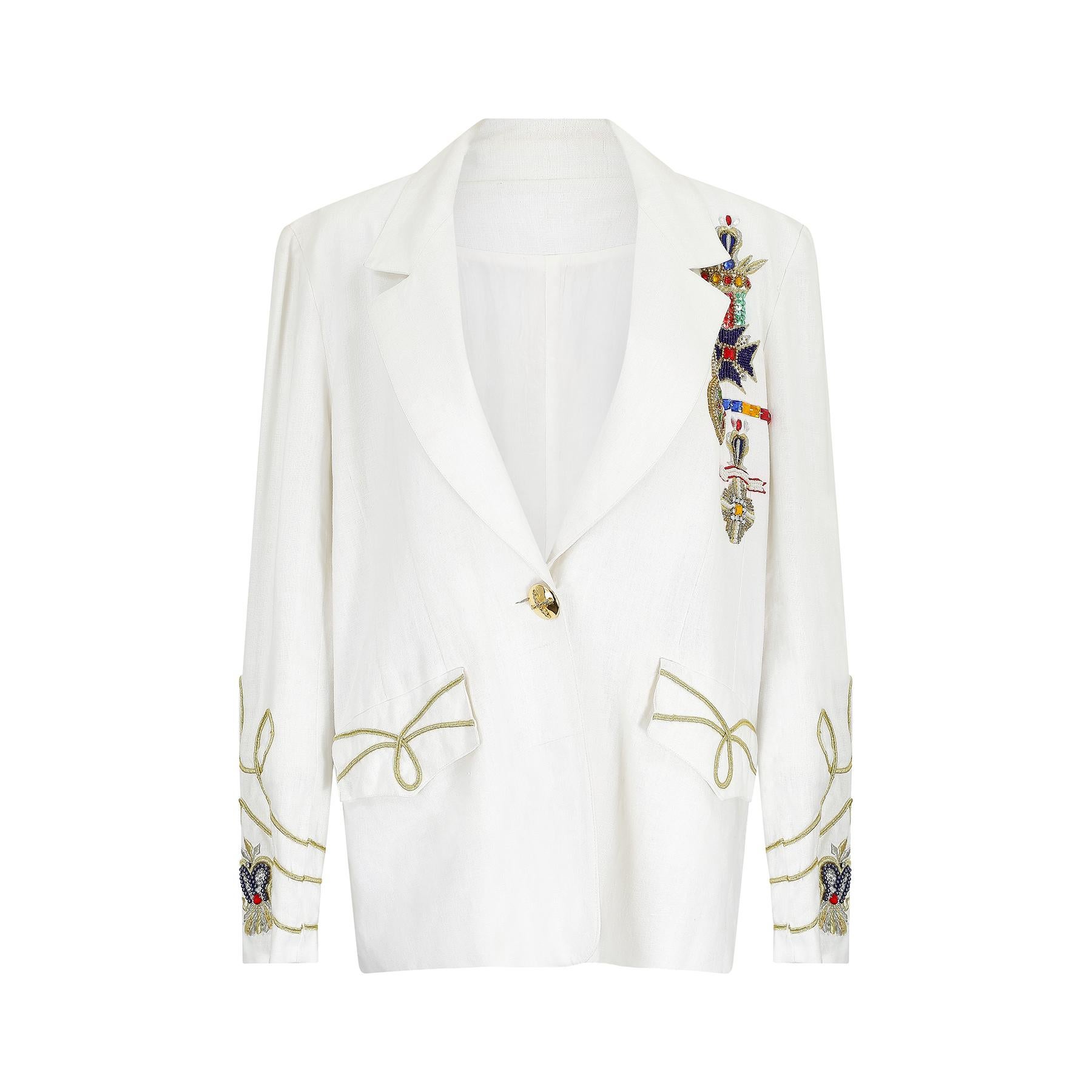Cette veste fantaisie en lin blanc de la fin des années 1980 au début des années 1990 a sans aucun doute été inspirée par les créations fantaisistes de Moschino et Versace. Ce modèle inhabituel est une version flamboyante de l'uniforme militaire et