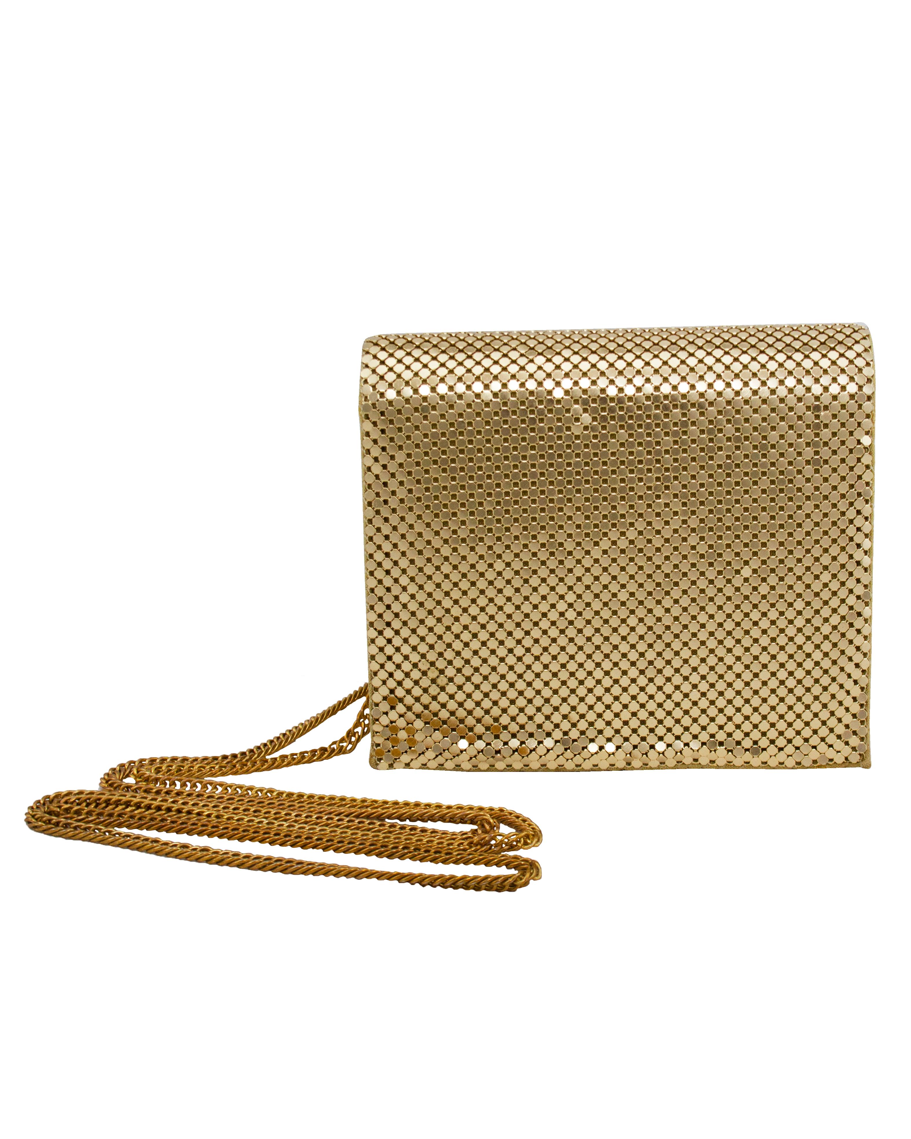 Fabulous Whiting and Davis mini bag from the 1980s. The iconic Whiting and Davis gold metal mesh with gold leather. Envelope style with a magnetic snap button closure. The long gold tone chain can be worn on the shoulder or crossbody. The chain can