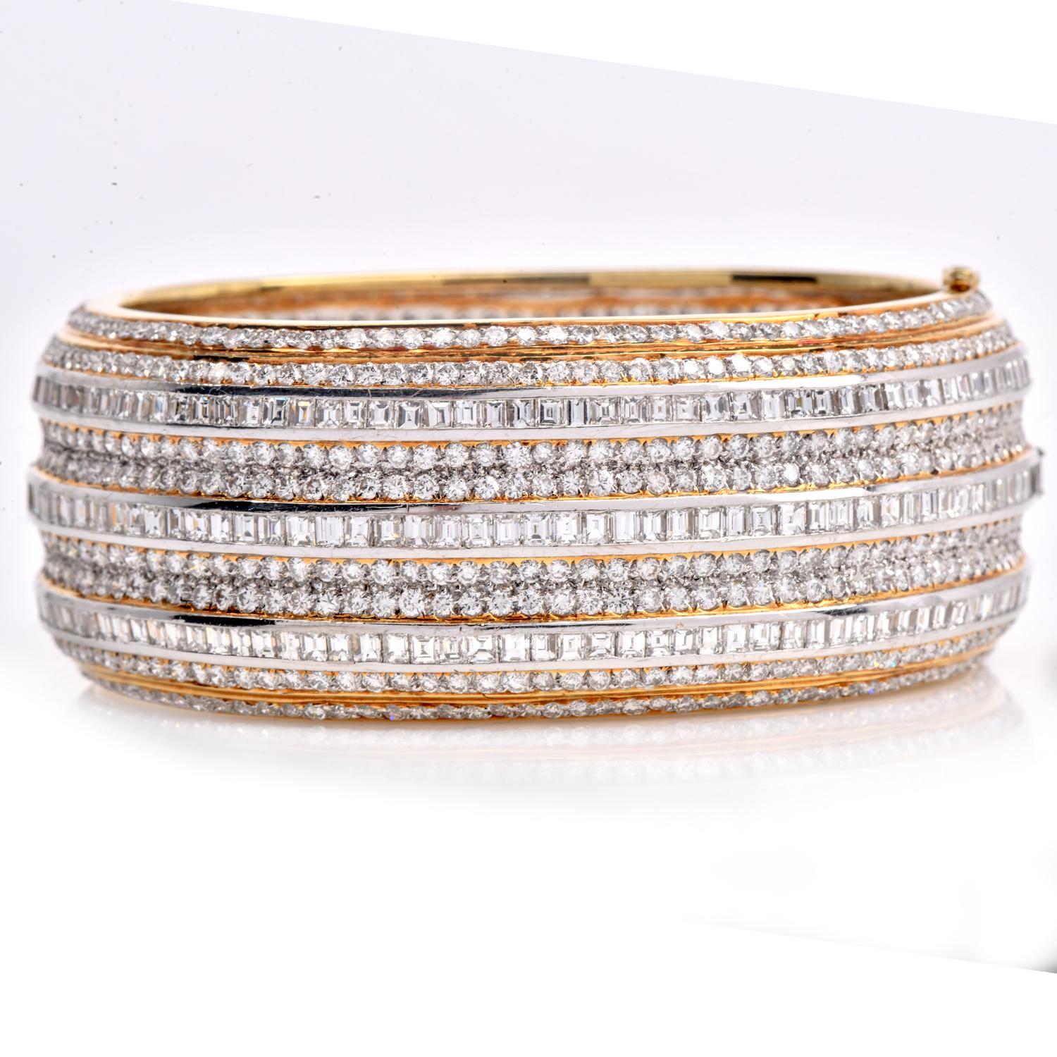 A truly special collectible piece of jewelry for a glamorous person, this diamond-wide statement bangle bracelet exudes opulence and refinement.

Expertly crafted in 18k white and yellow gold, this piece features a stunning array of round and