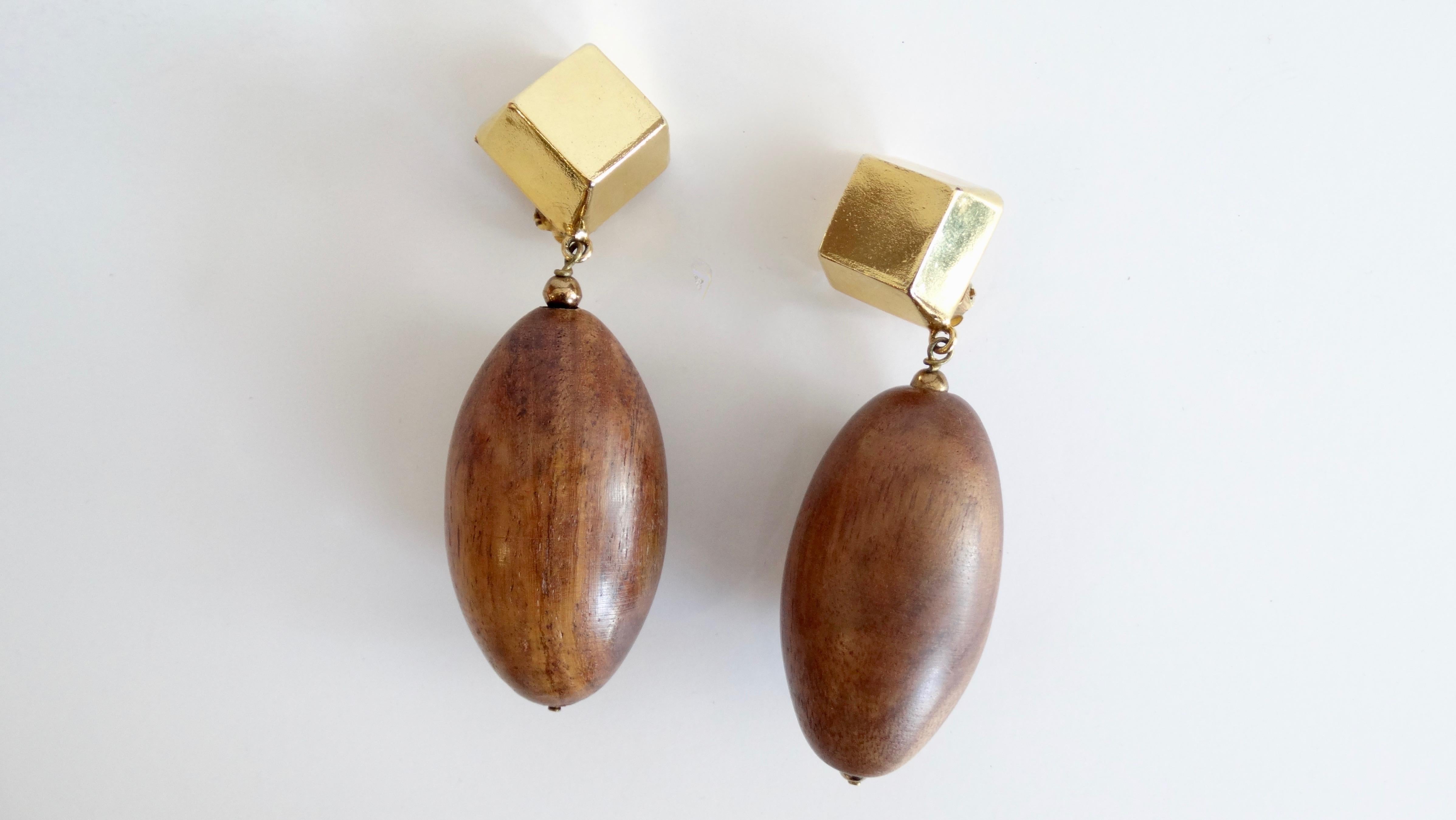 Add some vintage flair to your look with this unique pair of 1980s drop earrings! Made up of solid wooden beads suspended from gold metal geometric posts- the vintage version of Jacquemus earrings (best of all, nobody else will have these but you!)
