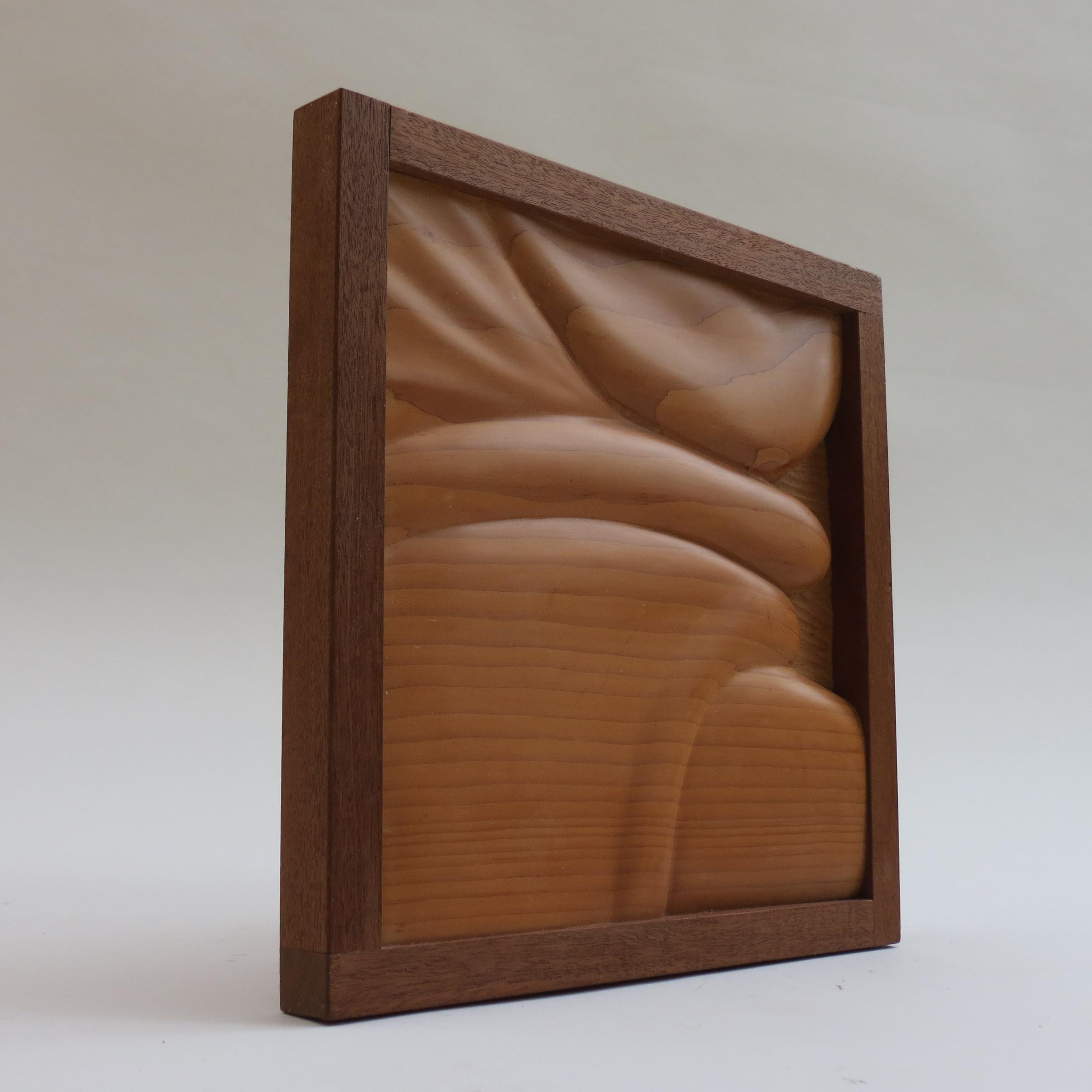 Wonderful wooden wall sculpture produced by Ian Gordon in the 1980s. Hand carved Douglas Fir Pine, with Brazilian Mahogany frame. 
Measures 30.5cm wide 29.5cm tall 2.5cm deep.
 