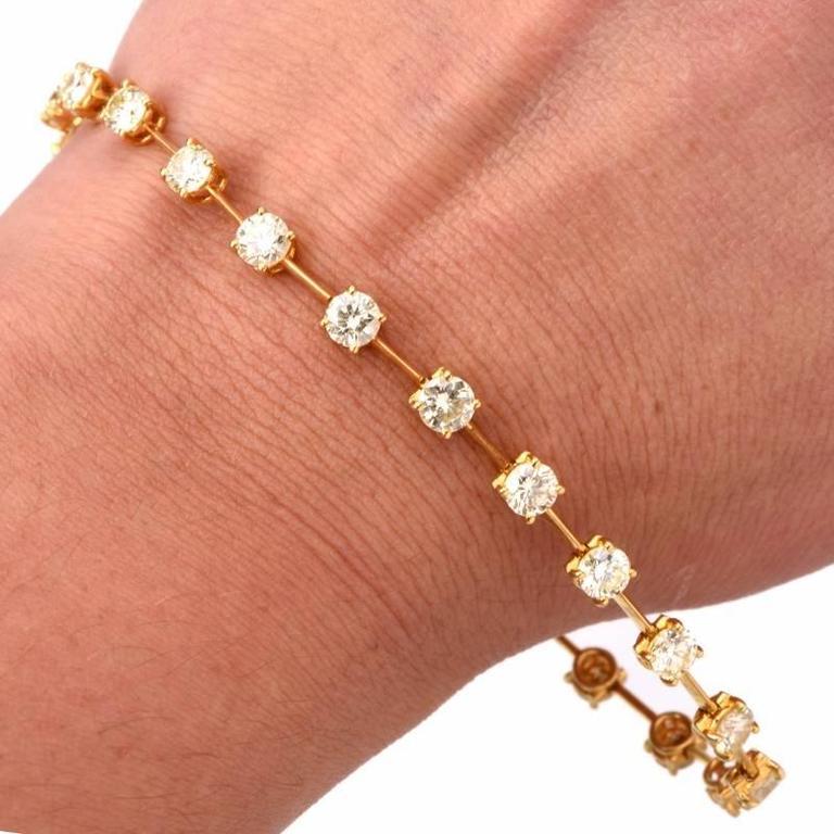 This alluring  diamond bracelet is crafted in solid 18K yellow gold, weighing 12.2 grams and measuring 8