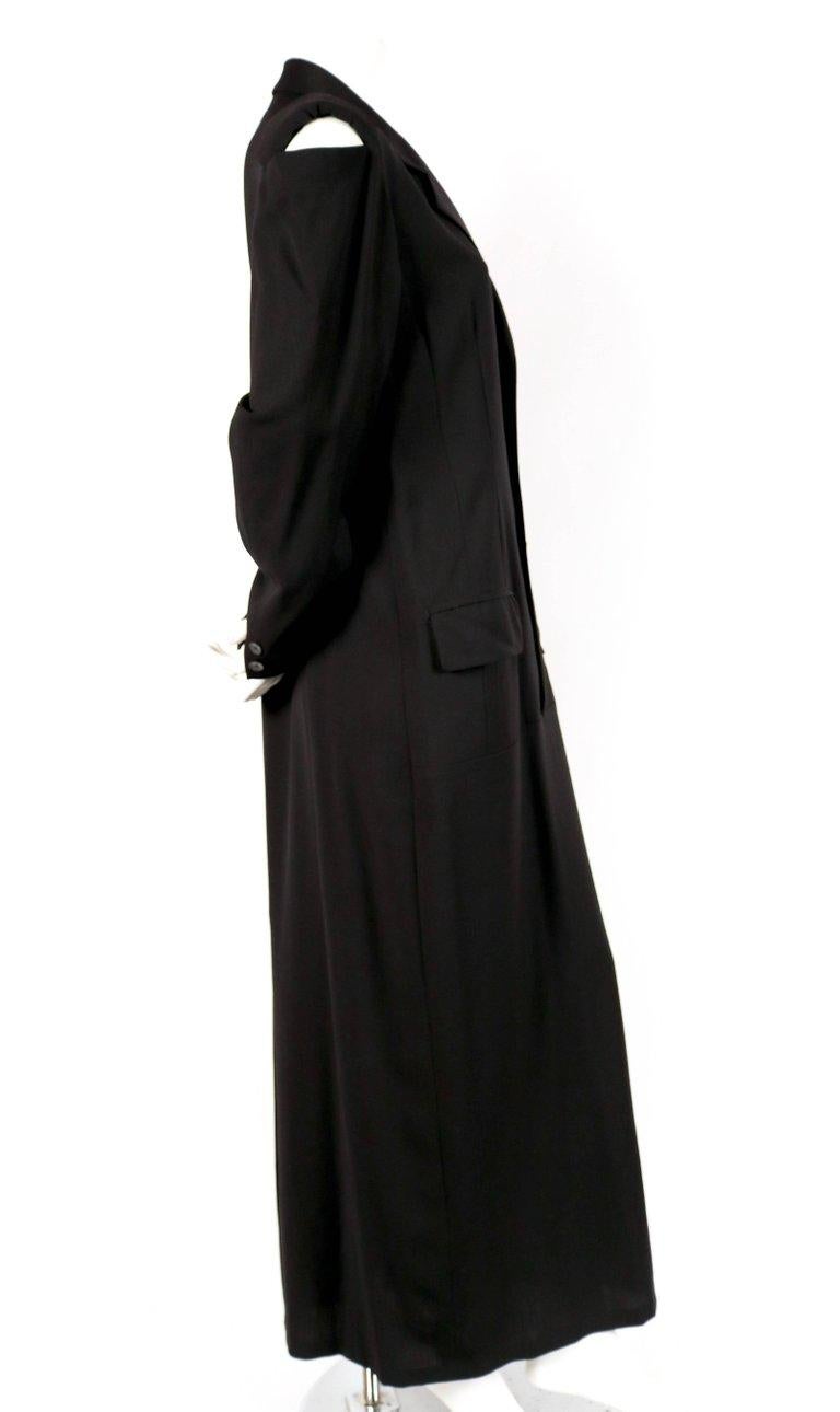 Black long men's style wool dress with cutout shoulders designed by Yohji Yamamoto dating to the 1980's. Labeled a size 'M'. Intended to have a loose oversized fit. Approximate measurements: shoulder 17.75