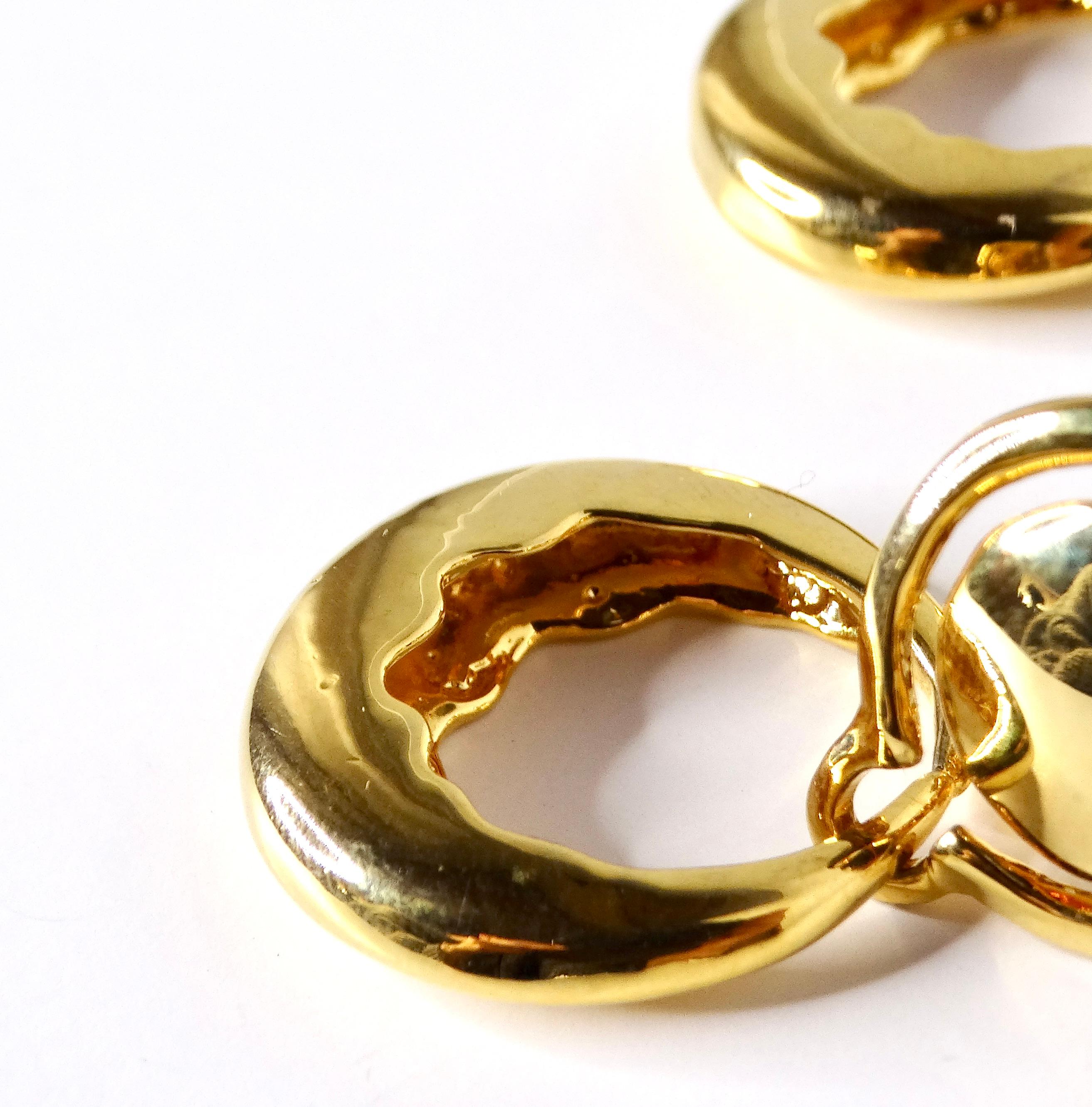 Step back into the glamorous 1980s with these YSL-inspired door knocker style earrings, elegantly crafted from high-quality 18k yellow gold plating. These statement earrings exude sophistication and boldness, making them the perfect accessory to