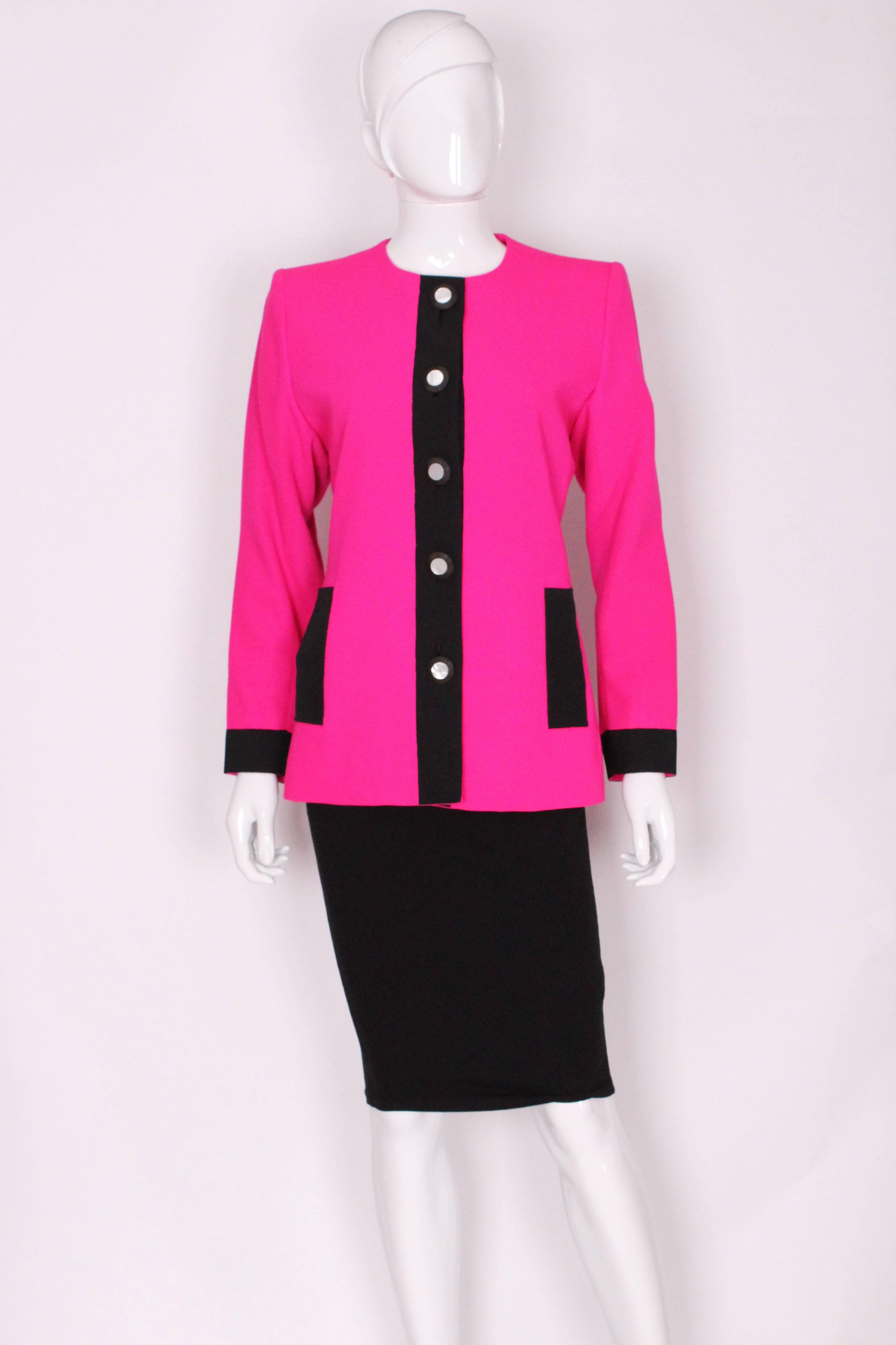 This is a really fun vibrant piece by YSL. It is quite a structured jacket which is synonymous with the 1980s. The contrast of the pink and black makes for a really bold piece. The fabric has a slight rib to it which gives great texture. There are 5