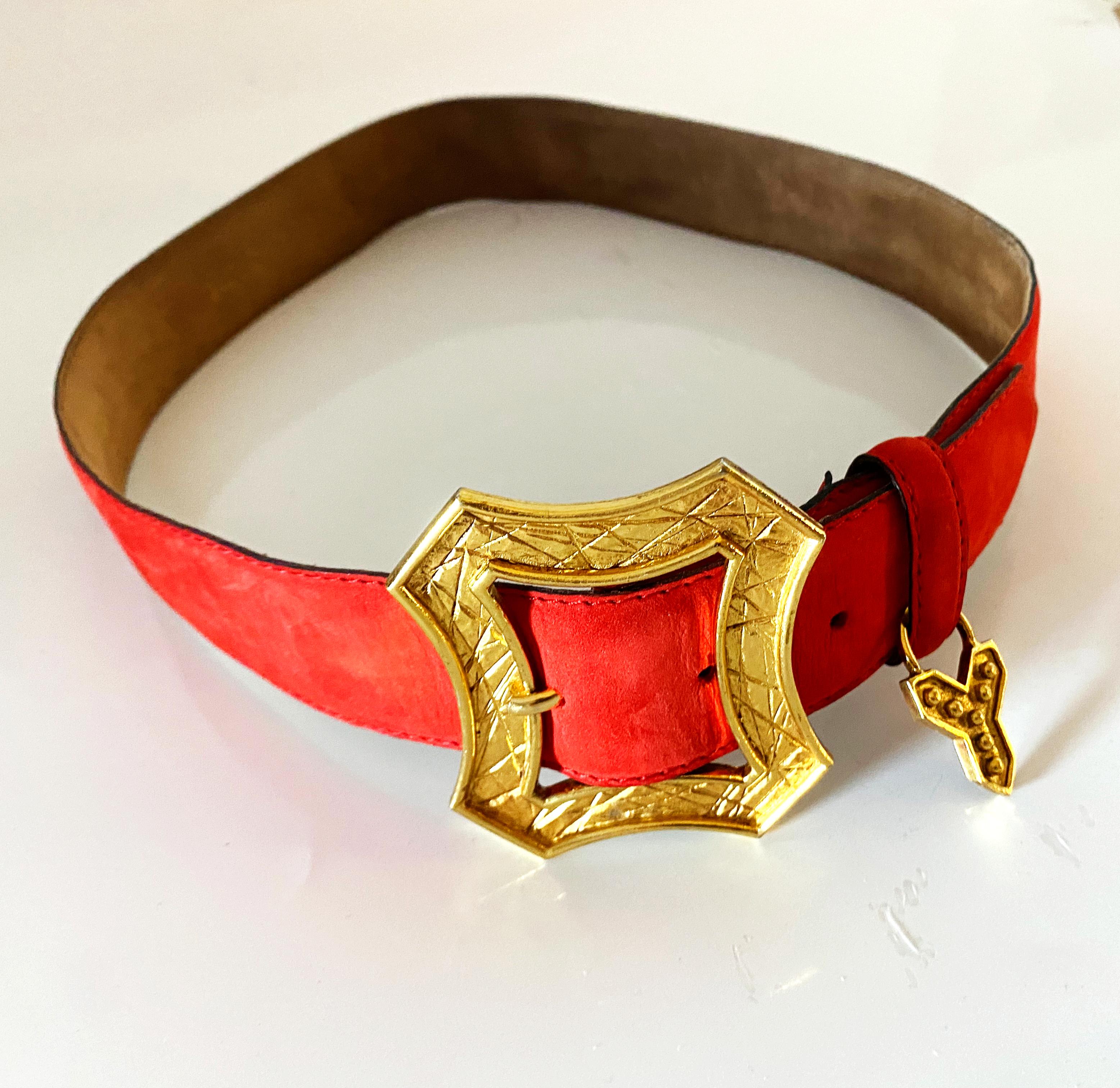 YSL's lobster-red suede leather belt is the perfect adornment for any ensemble, featuring a gold-tone metalware charm with the iconic Y initial, all crafted with luxurious precision in France.

Measurements: flat waist measurement 29-31