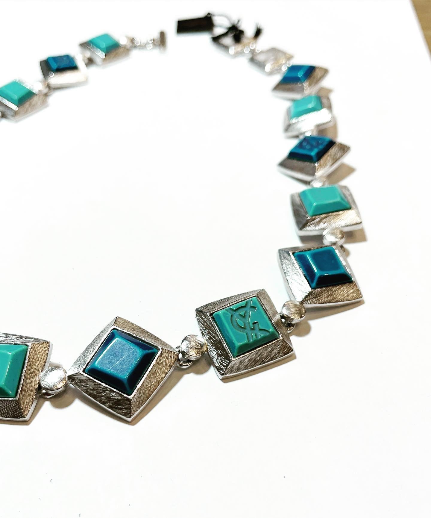1980s gorgeous vintage YVES SAINT LAURENT  blue colour resin and Silvered square shape necklace! 
Gilt chain with the YSL logo. 
Can really add just that little extra elegance to any outfit! 
Great with jeans, and perfect with a dress.
You can wear