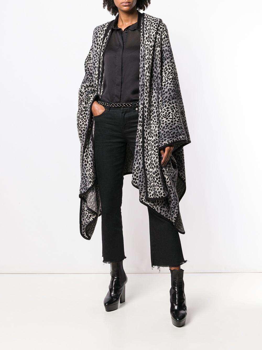 Stylish Yves Saint Laurent black, white and grey animalier print poncho-style oversize cape, opened long sleeves, no closure, mid-length asymmetrical hem and black edges. It includes a detachable hood with long flaps that look like a scarf.
Years: