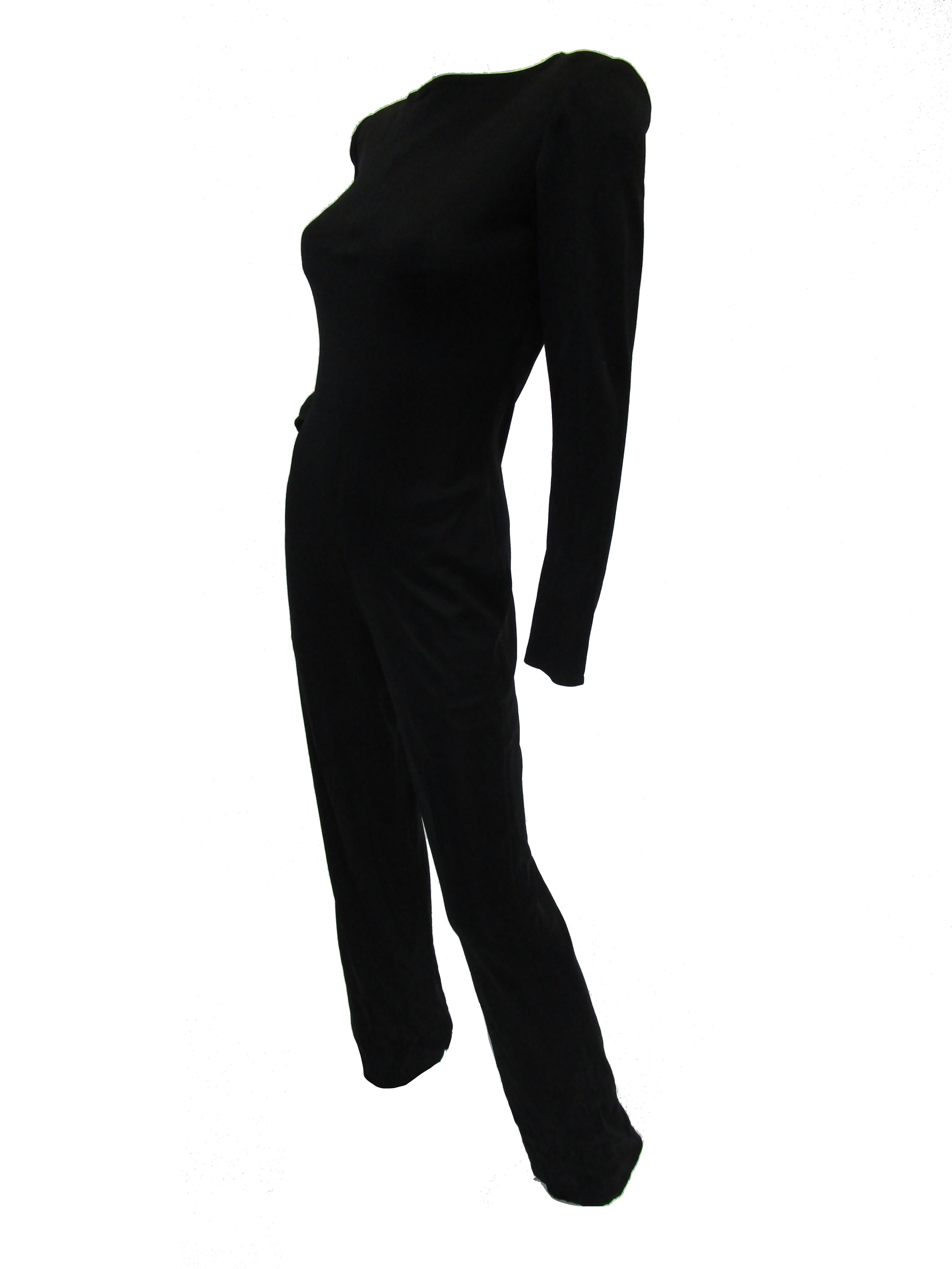 Simple and chic black silk blend jumpsuit by Yves Saint Laurent. The jumpsuit skims the body, with a somewhat fitted waist, long sleeves, and long pants. Bateau neckline adds a bit of french flair. The jumpsuit is classic, and evokes thoughts of a