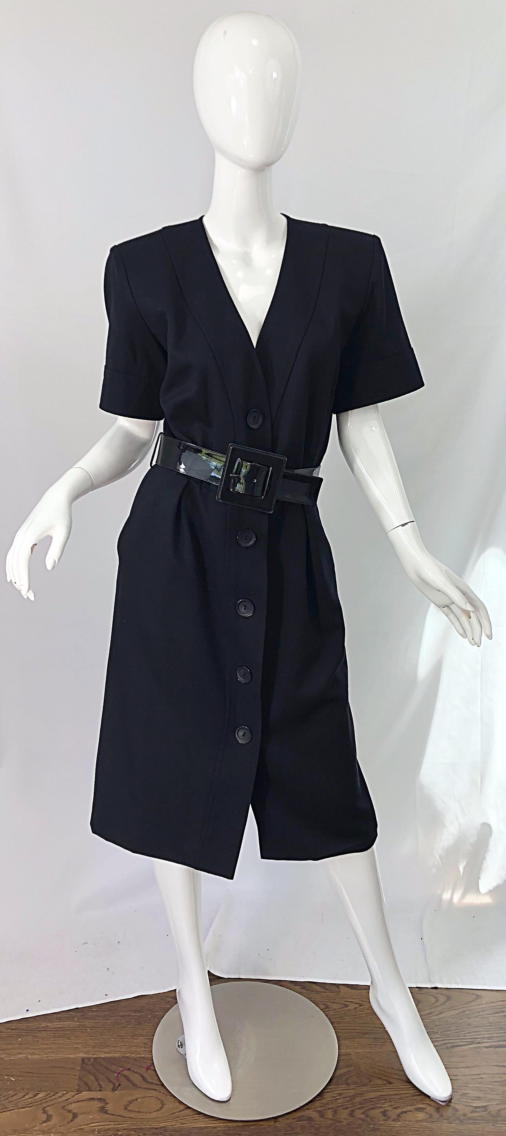 Chic and classic early 1980s YVES SAINT LAURENT YSL Rive Gauche black short sleeve belted dress ! Features buttons up the entire front of the dress. Pockets at each side of the hips. Original detachable black patent leather belt is also marked Yves