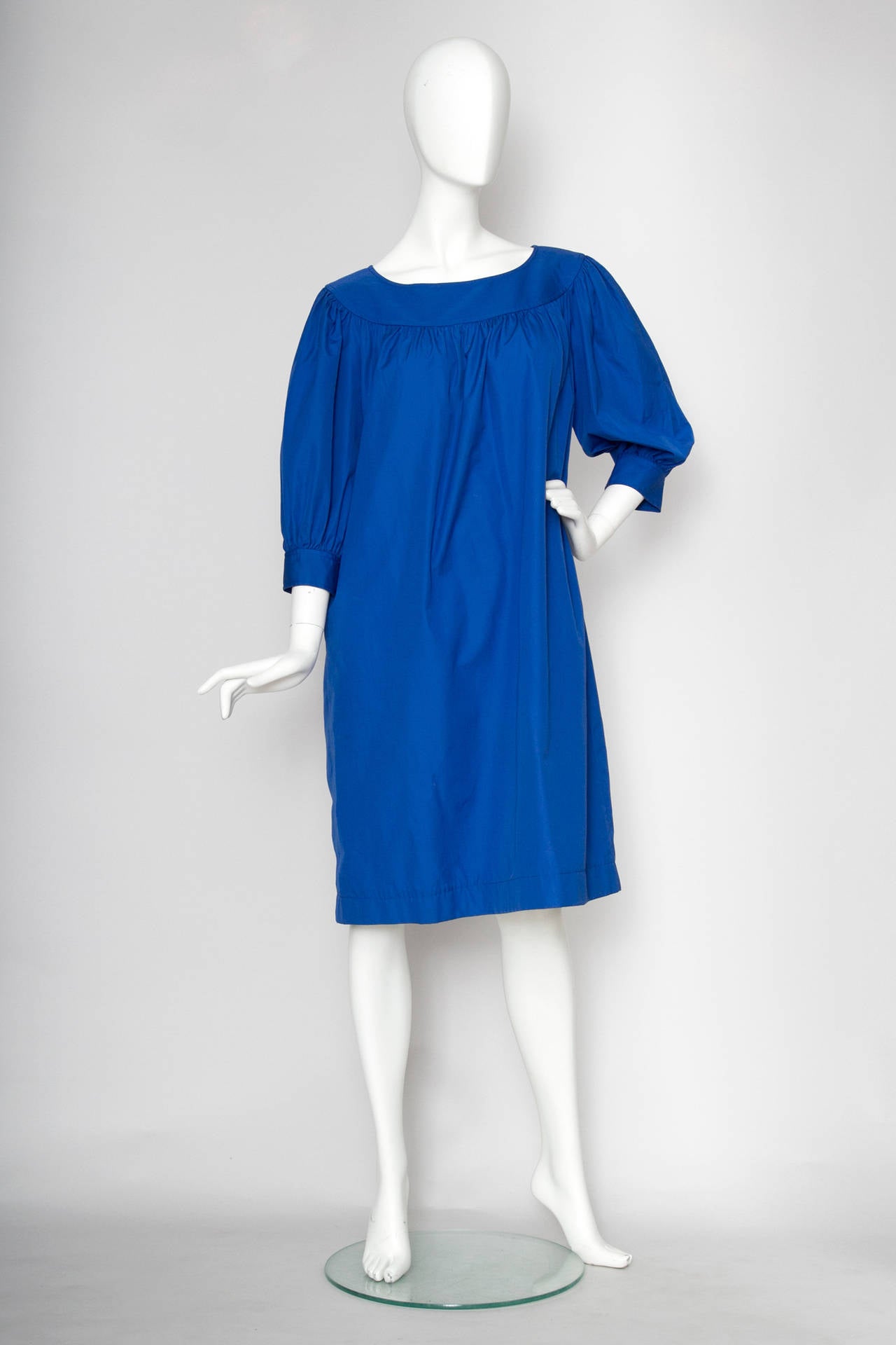 A 1980s Yves Saint Laurent Variation peasant cotton dress in a gorgeous blue colour with three quarter length voluminous sleeves, a scoop neckline and invisible side pockets. 

The dress appears to be in unworn condition with original labels