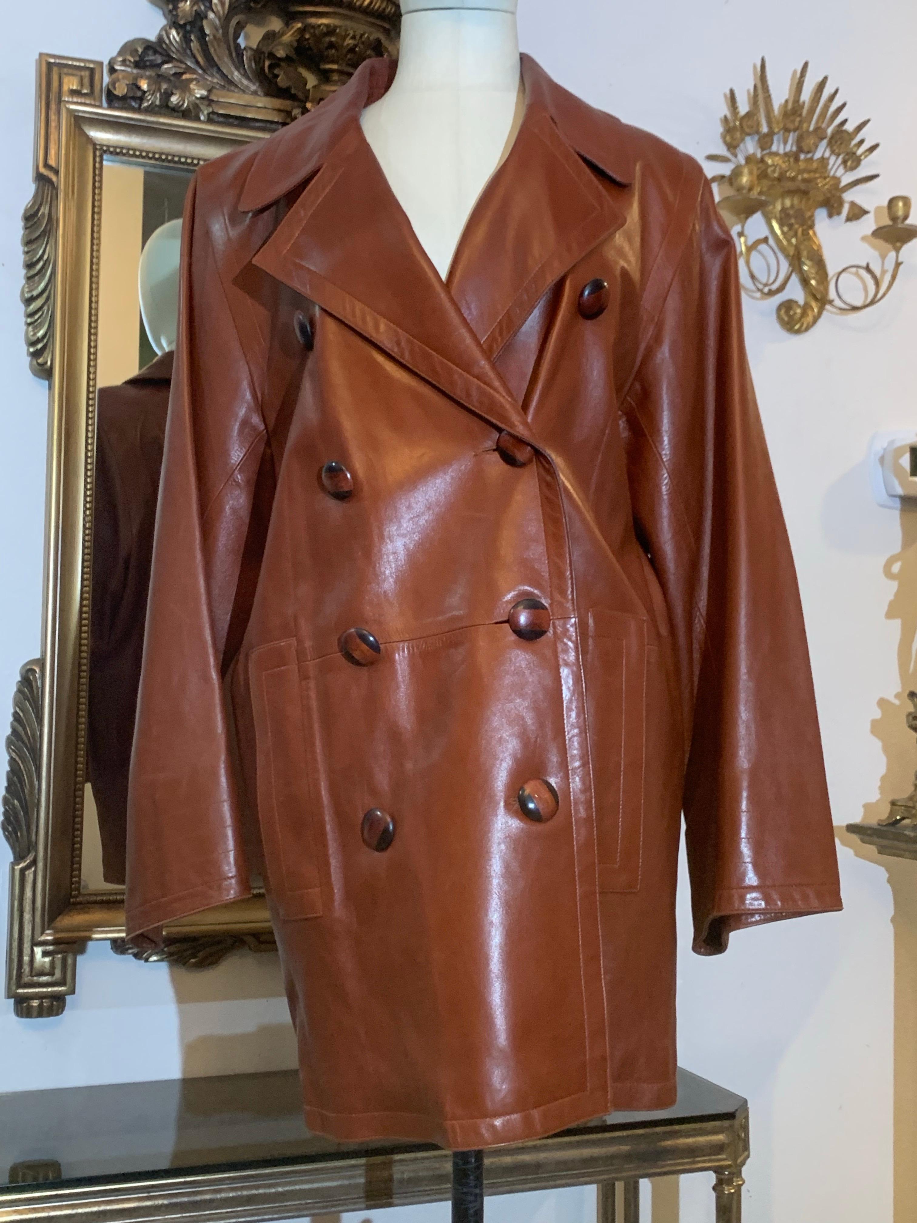 1980s Yves Saint Laurent Cognac Lambskin Leather Double-Breasted Trench Coat:  Supple lambskin leather in a classic style!  Oversized with wide notched collar, batwing sleeves, polished wooden buttons. Side slit pockets. Lined in matching satin.