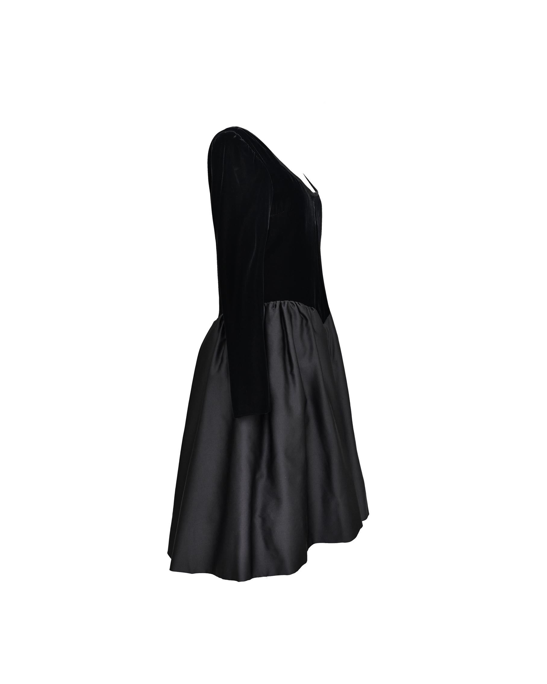1980’s Yves Saint Laurent Couture black cocktail dress with scoop neck velvet upper and lined, voluminous silk taffeta flare skirt. Zips up back and sides of wrists. 