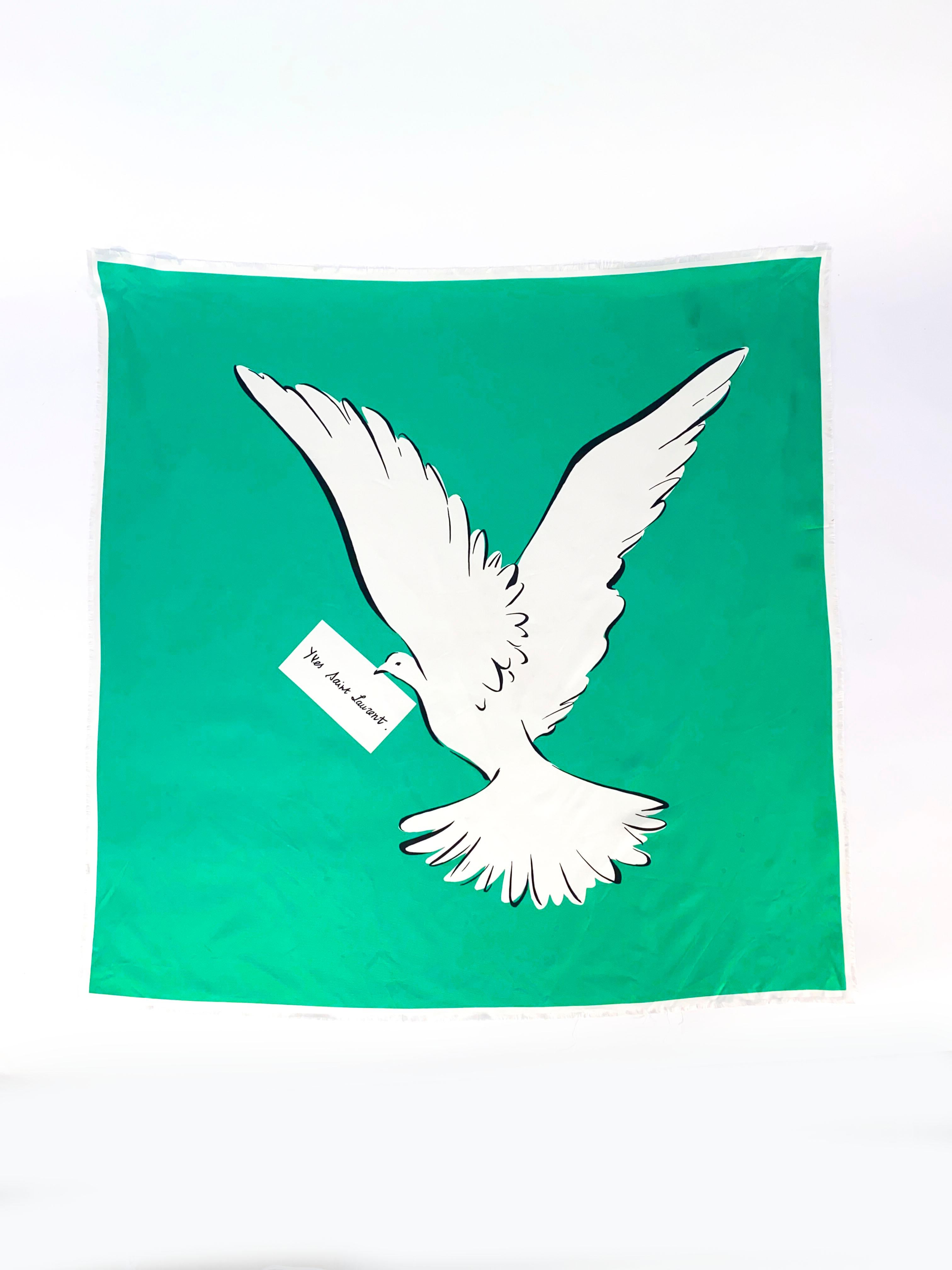 1980's Yves Saint Laurent silk scarf in green featuring a white dove of peace. The edges are stylistically frayed and have a slight white boarder. 