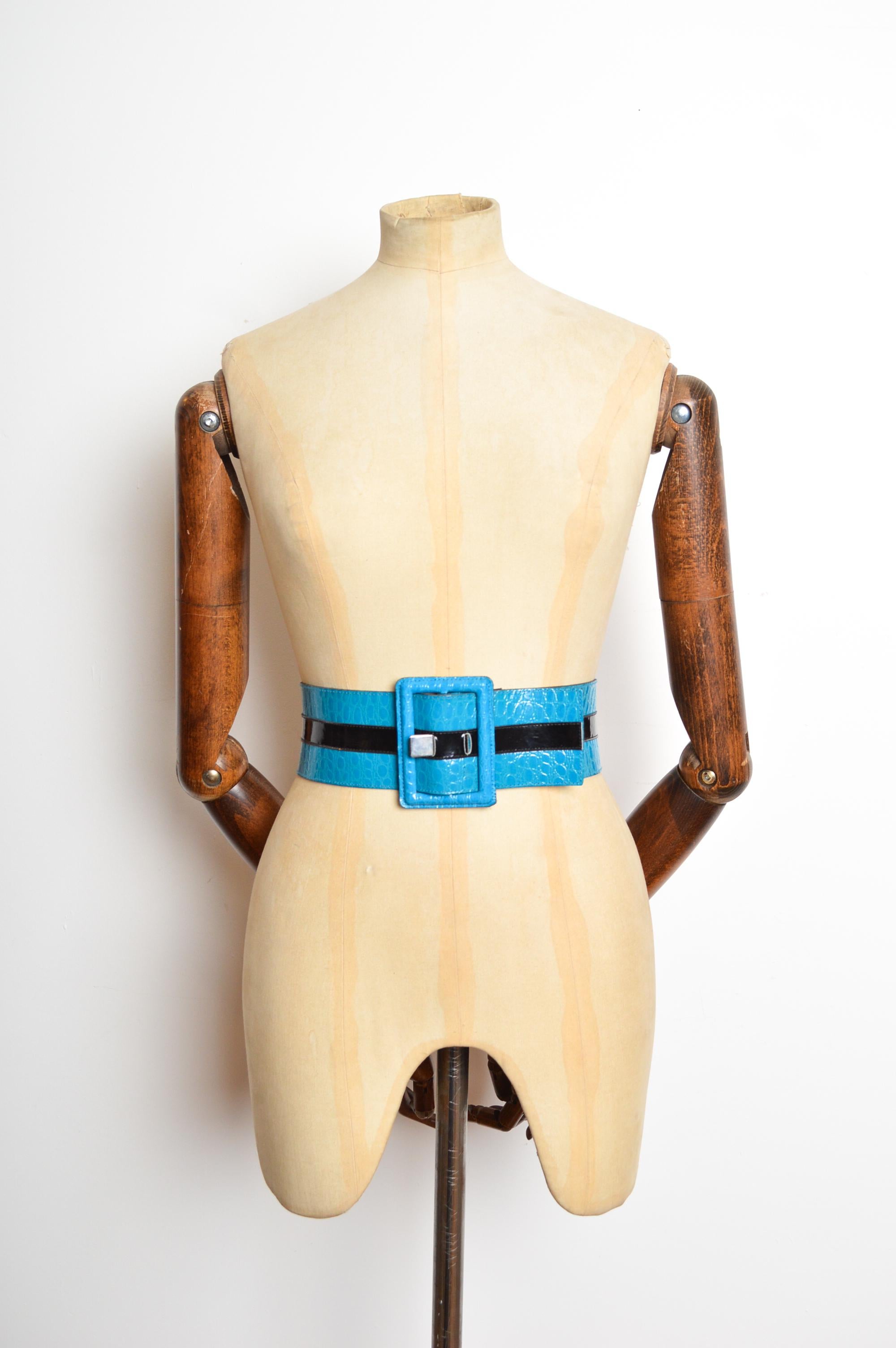 Una favolosa cintura di Yves Saint Laurent del 1980. Realizzate in finta pelle di vernice stampata in blu elettrico con una striscia nera a contrasto al centro e una grande fibbia. 
PRODOTTO IN FRANCIA.  
Le misure sono indicate in pollici