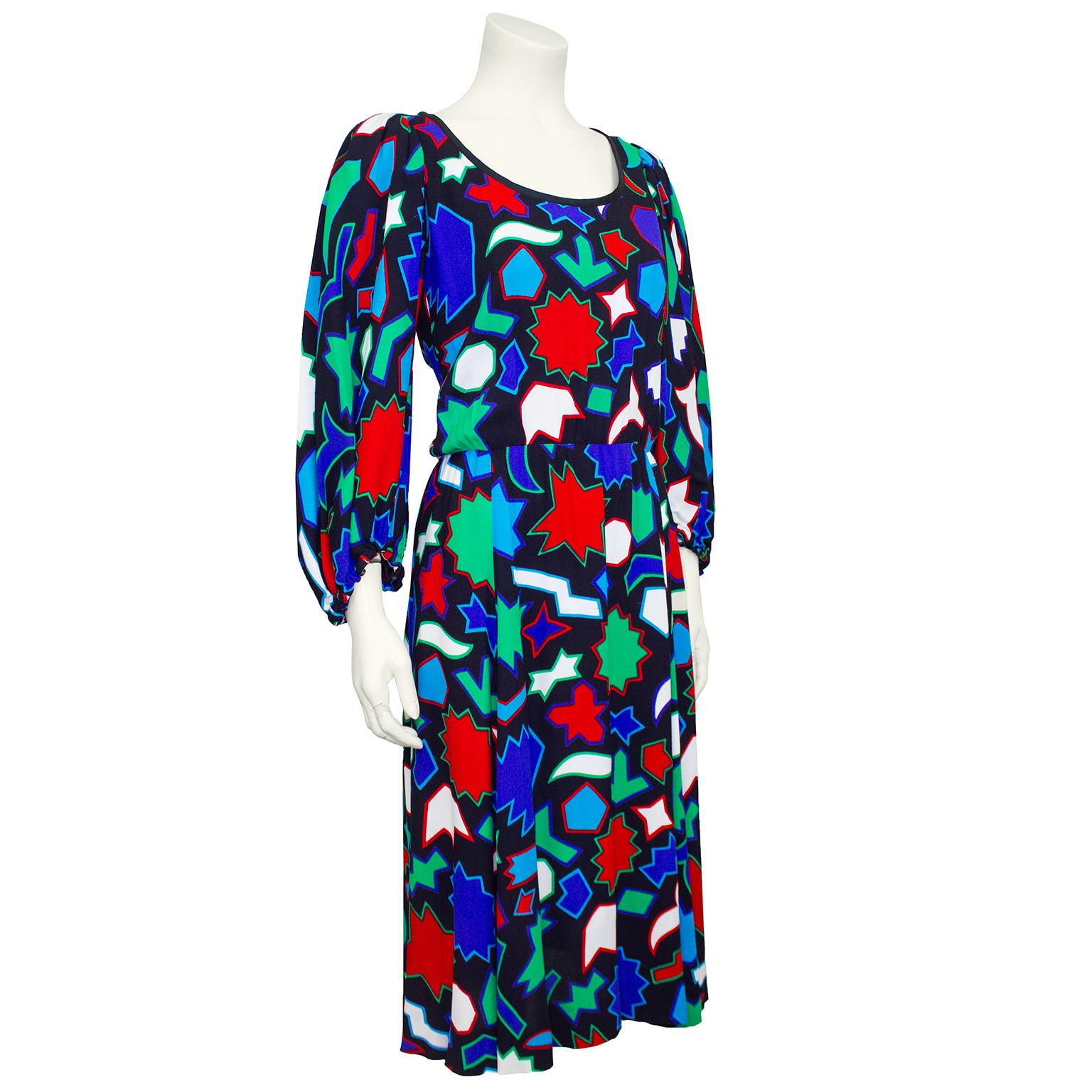 1980s Yves Saint Laurent Rive Gauche rayon crepe de chine dress. Allover blue, red, green and white geometric print. Scoop neckline with black trim and bishop sleeves with elastic cuffs. Fits slightly loose in the body with a waistband and flowing