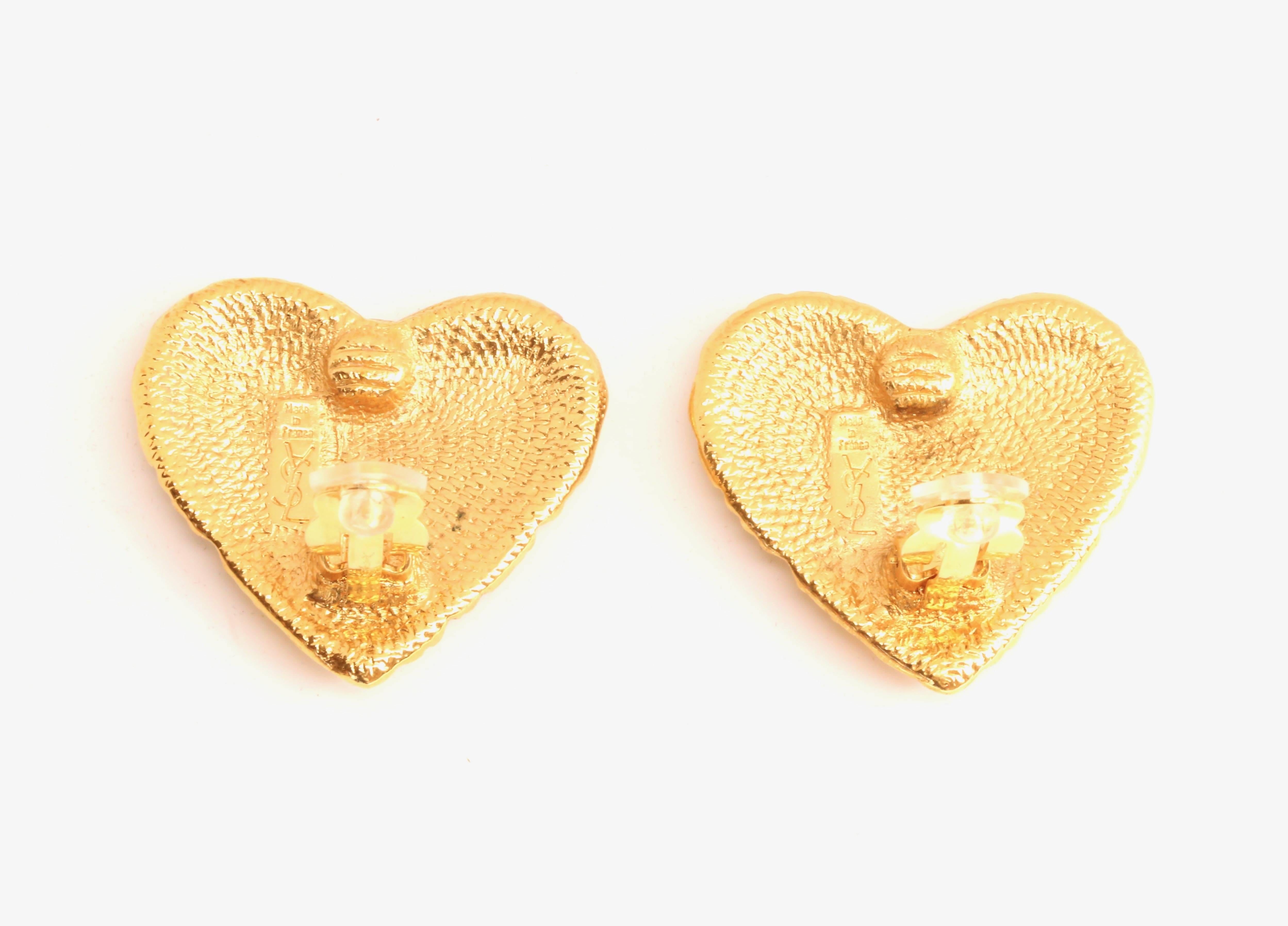 Gilt textured heart shaped earrings from Yves Saint Laurent dating to the 1980's. Clip backs. Measure approximately 1.5
