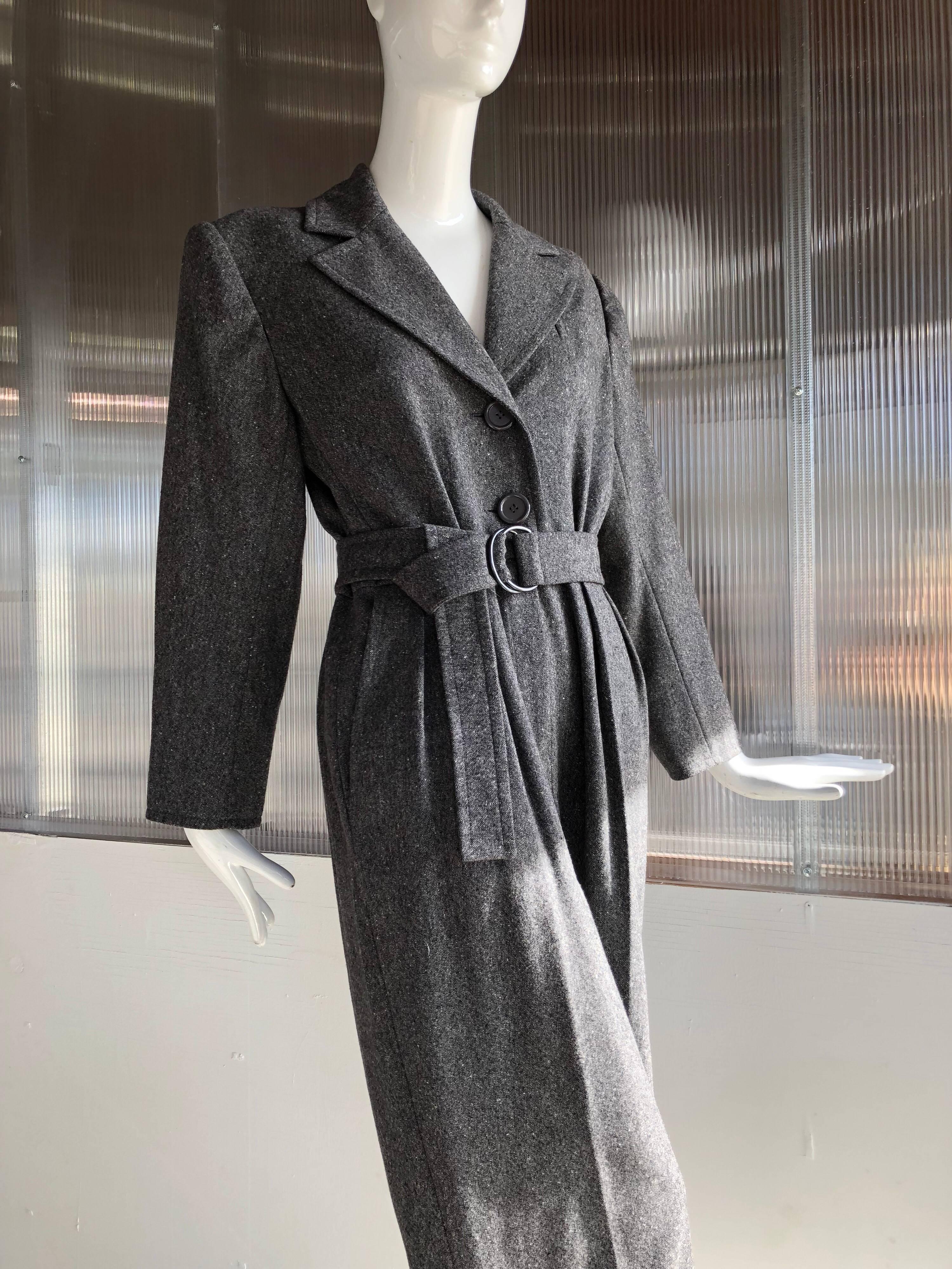 A gorgeous 1980s Yves Saint Laurent menswear-styled trench-inspired charcoal gray speckled wool jumpsuit with wide creased and cuffed legs, large notched lapel and buttons to waist.  Zipper at front of pants.  Original belt included.  