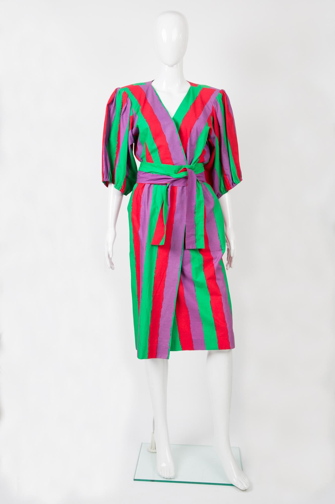 Yves Saint Laurent multicoloured cotton wrapped dress featuring a stripy pattern, a separated belt, shoulder pads, large puffy sleeves with elasticated cuff, back button opening, front pockets. 
100% cotton
In good vintage condition. Made in France.