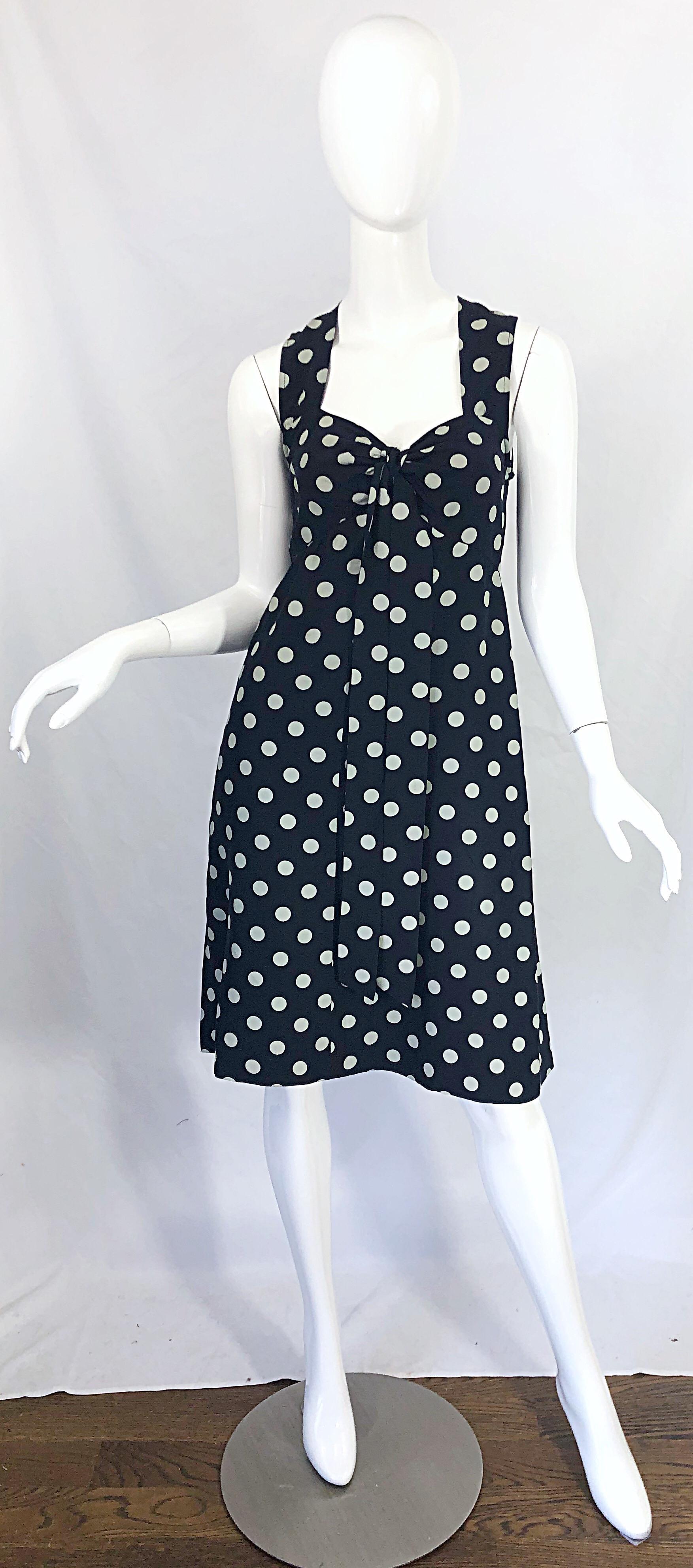 Chic early 1980s YVES SAINT LAURENT Rive Gauche navy blue and white polka dot silk sleeveless dress ! Features a tailored bodice with a flowy skirt. Tie details at center bust that fall to the hem. Hidden zipper up the back with hook-and-eye
