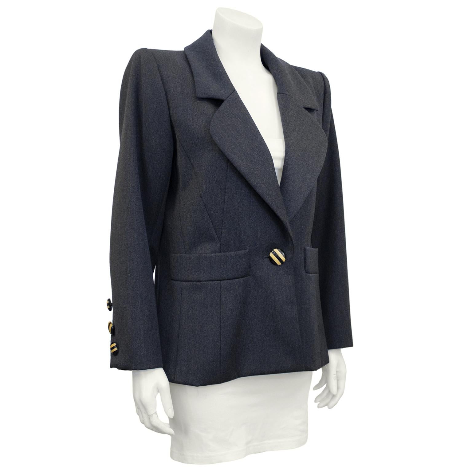 Early 1980s Yves Saint Laurent Rive Gauche blazer. Grey wool with interesting seaming to create a beautiful slightly fitted shape. Statement large striped wood buttons. Single button closure at centre front and three on each cuff. Excellent vintage