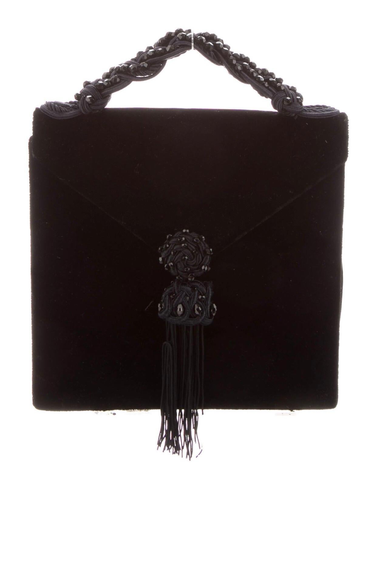 1980s Yves Saint Laurent black velvet bag with tassel and top handle. 
Condition: Excellent
Snap closure at front. Singe interior pocket. 
7.5
